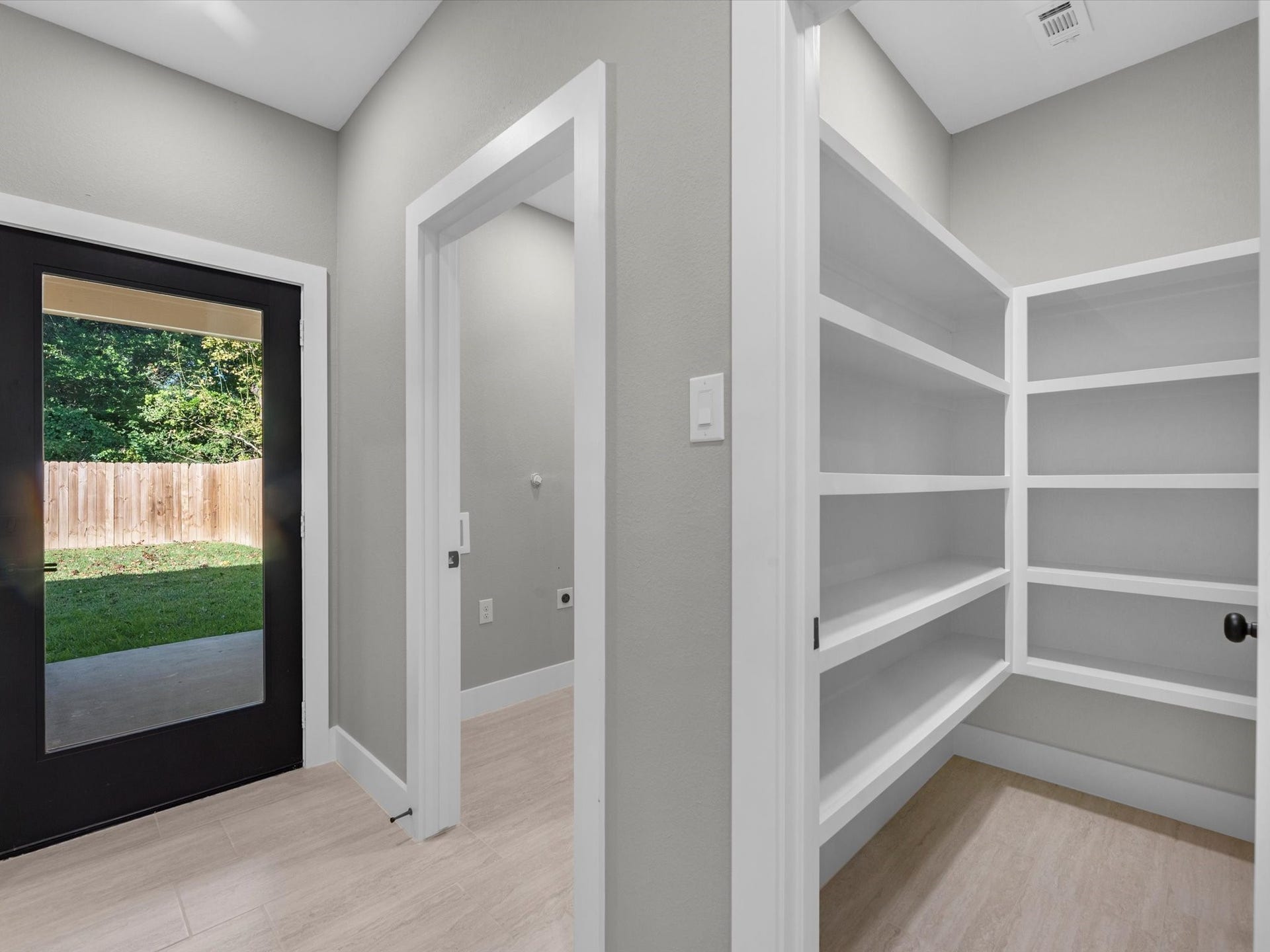 8709 Wheatley Street, Houston, TX 77088 Unit A: Convenient hallway with built-in shelving, storage, and laundry area.