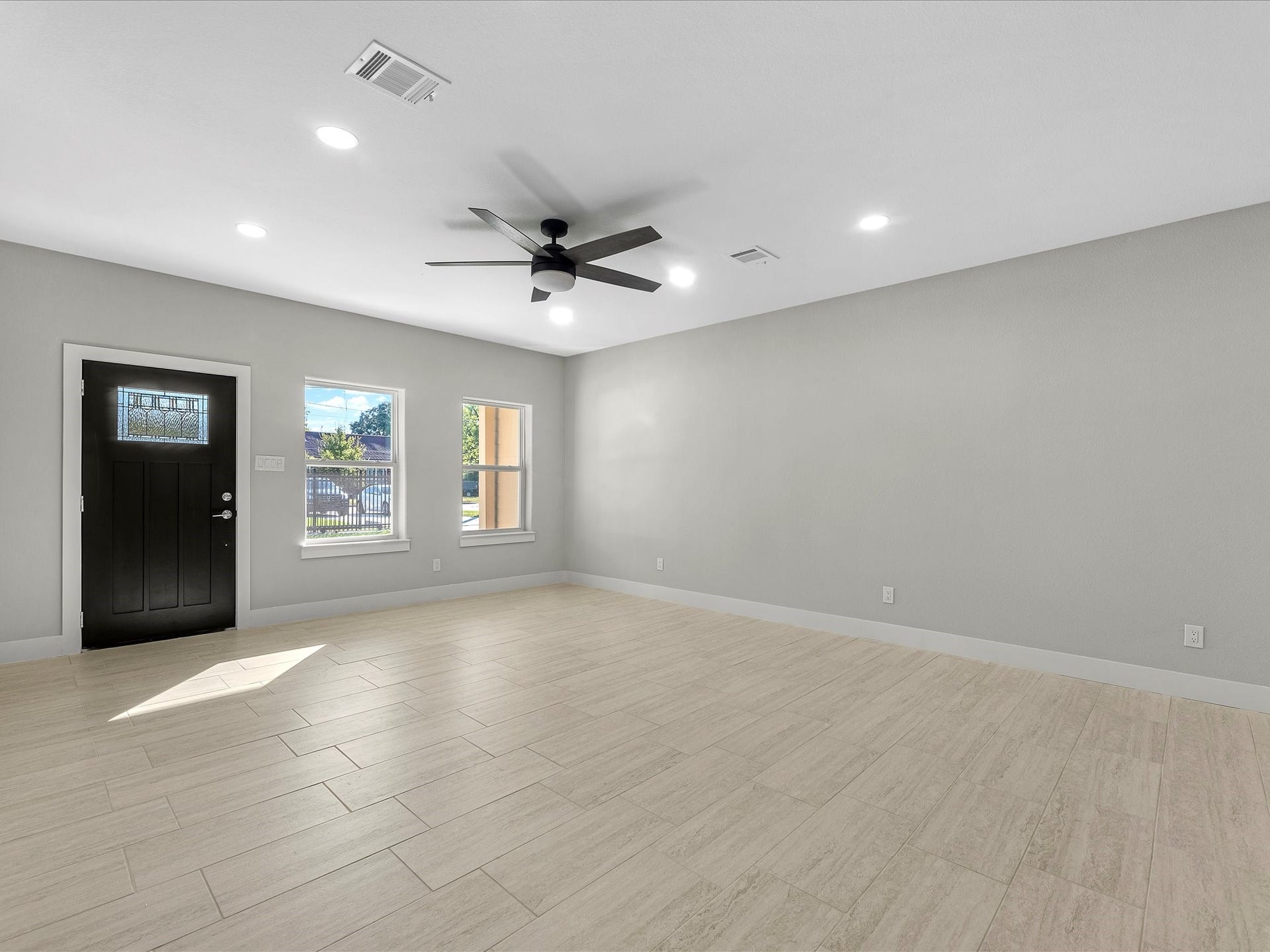 8709 Wheatley Street, Houston, TX 77088 Unit B: Spacious living area with natural light and flexible furniture arrangements.