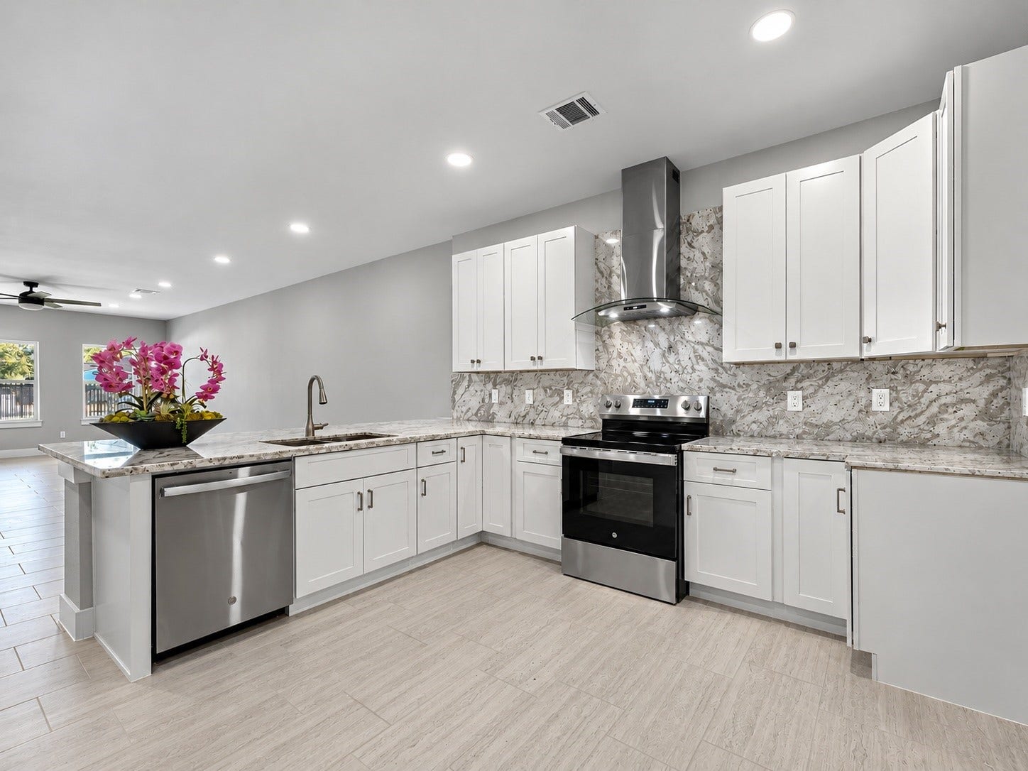 8709 Wheatley Street, Houston, TX 77088 Unit B: Modern kitchen with granite countertops, stainless steel appliances, and white cabinetry.