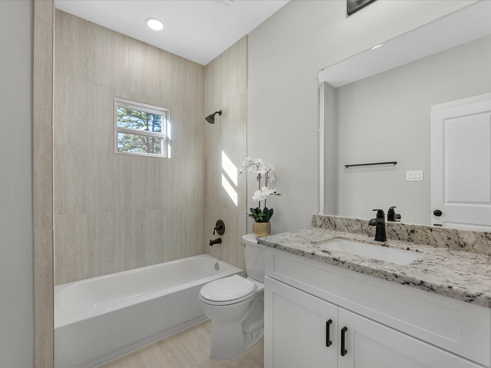 8709 Wheatley Street, Houston, TX 77088 Unit B: Primary bathroom featuring modern vanity, contemporary finishes, and tub/shower combination.