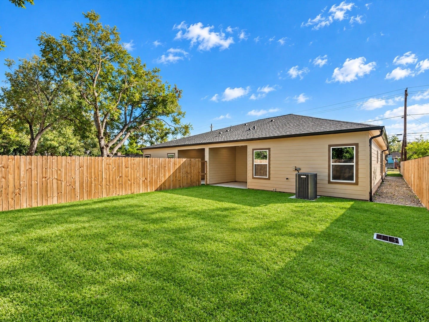 8709 Wheatley Street, Houston, TX 77088 Unit A: Private fenced backyard with green lawn and room for outdoor enjoyment.