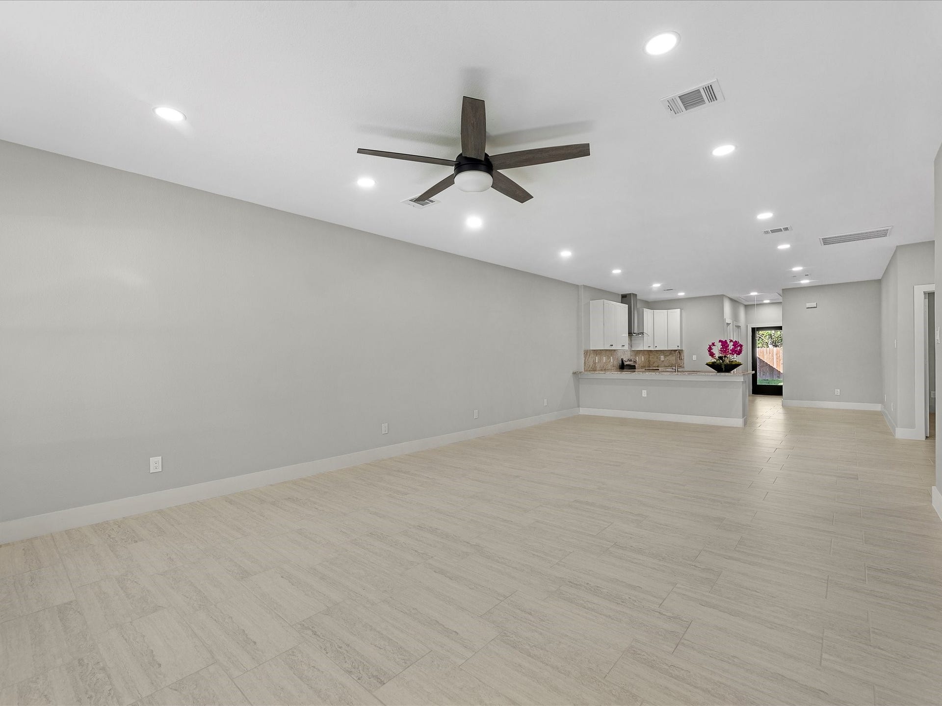 8709 Wheatley Street, Houston, TX 77088 Unit B: Open-concept living and dining area with modern flooring and recessed lighting.