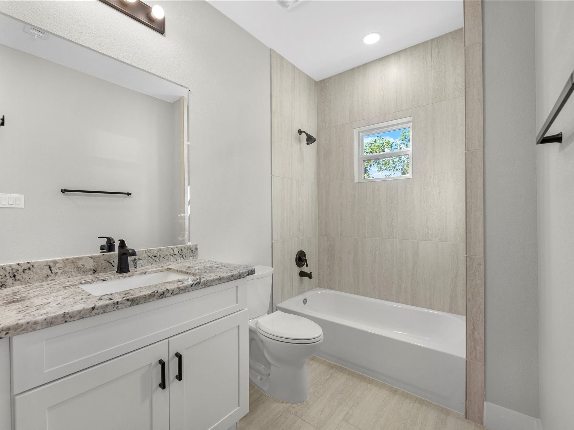 8709 Wheatley Street, Houston, TX 77088 Unit B: Secondary full bathroom with modern fixtures and neutral finishes.