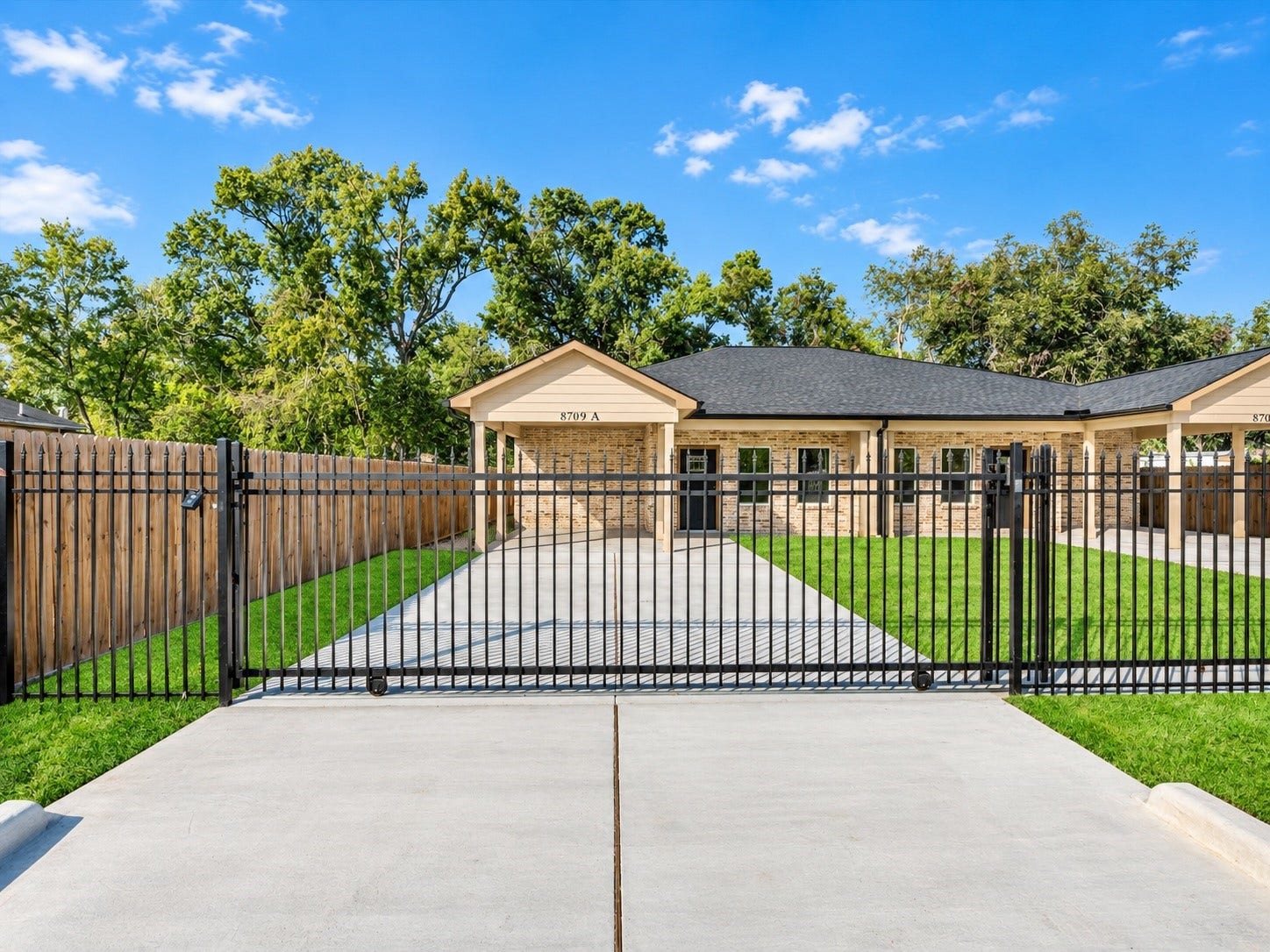 8709 Wheatley Street, Houston, TX 77088 Unit A:Private gated driveway and covered entrance offering convenience and privacy.