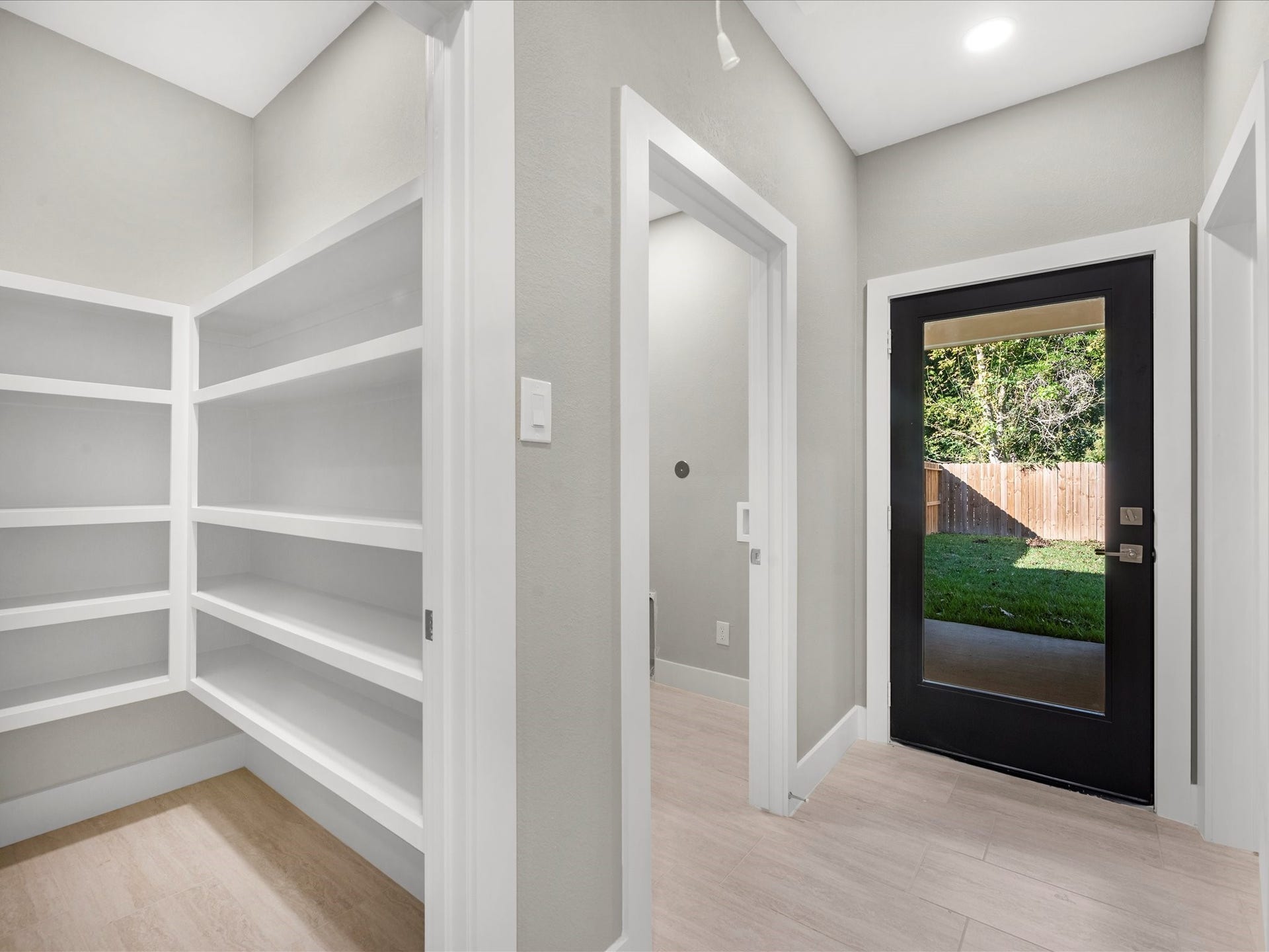 8709 Wheatley Street, Houston, TX 77088 Unit B: Hallway with built-in shelving, additional storage, and laundry area.