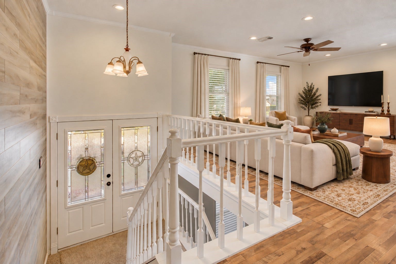 Heading downstairs toward the second living area and primary suite *virtually staged*