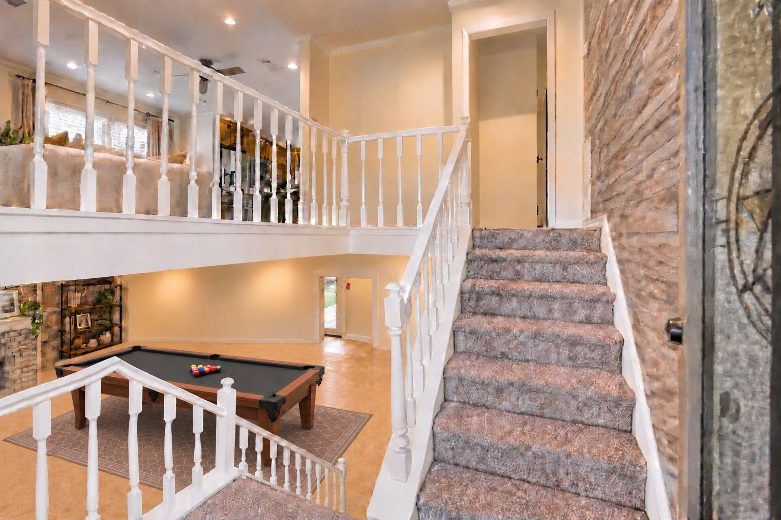 As you enter the home, you are greeted with a split level floor plan with a secondary living room downstairs.
