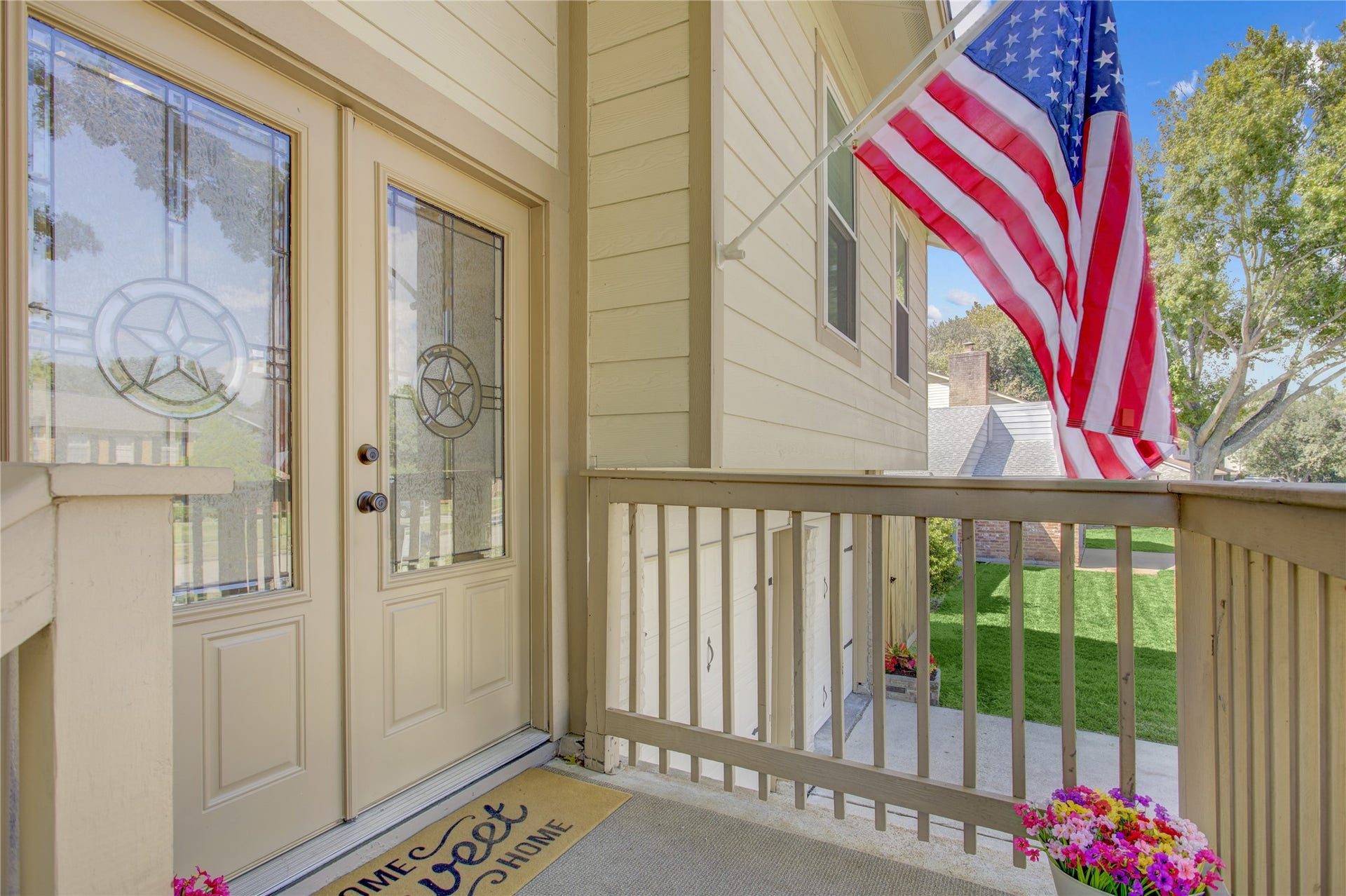 As you walk up the exterior steps, you are greeted with a spacious landing and double doors.