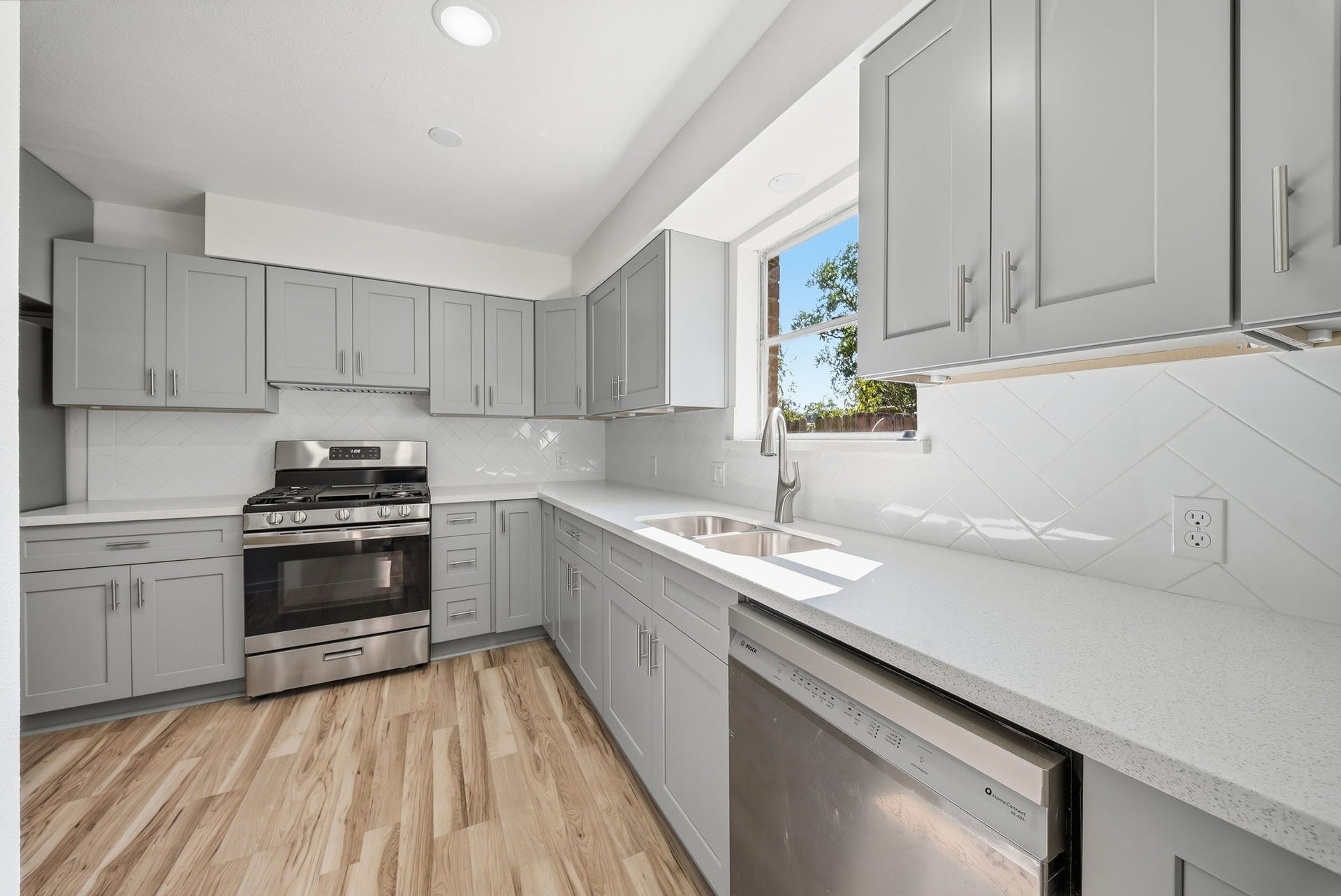 3027 Longhorn Drive, Rosenberg, TX 77471 White counters, diagonal tile backsplash and a dishwasher keep cleanup simple.