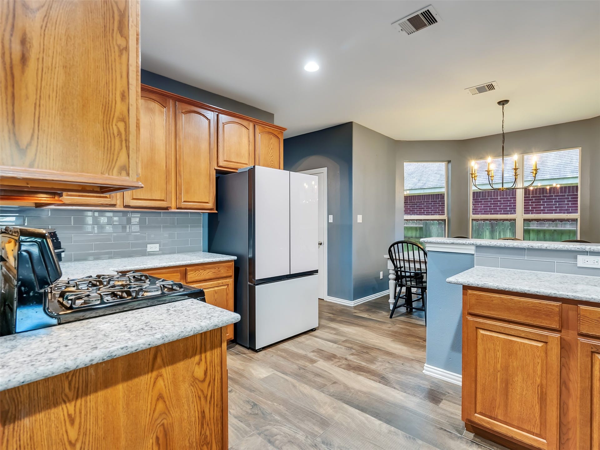 This fantastic kitchen over looks the breakfast room with walls of windows