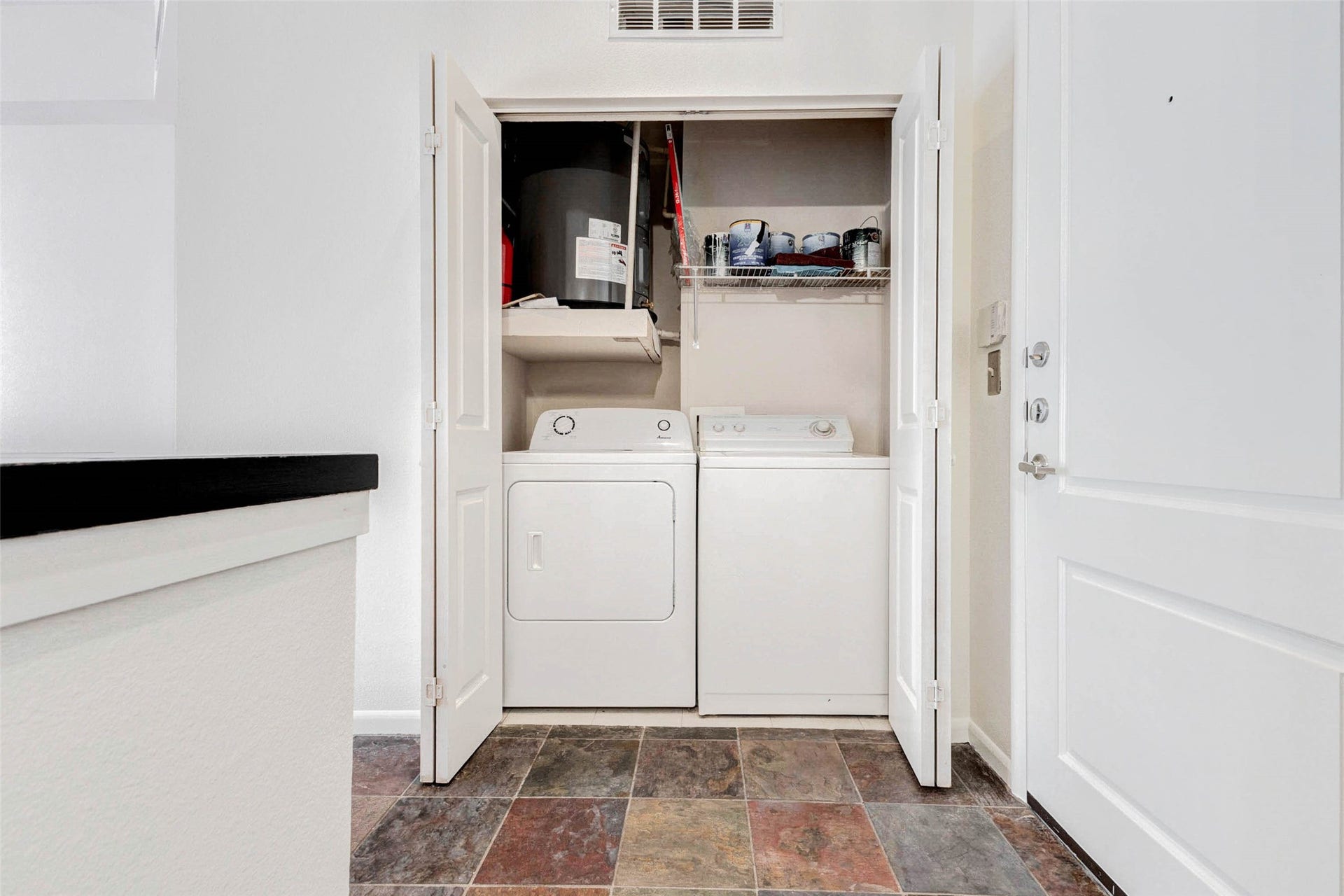 3505 Sage Road, #1104, Houston, TX 77056 Convenience meets functionality with this in-unit laundry closet featuring a full-size washer and dryer tucked neatly behind double doors. Located just off the entry area, this laundry space makes everyday living simple and efficient. Overhead shelving provides additional storage for supplies and household items, while the enclosed design keeps the space organized. Having your own washer and dryer inside the unit adds a valuable level of comfort and practicality to this stylish high-rise home.