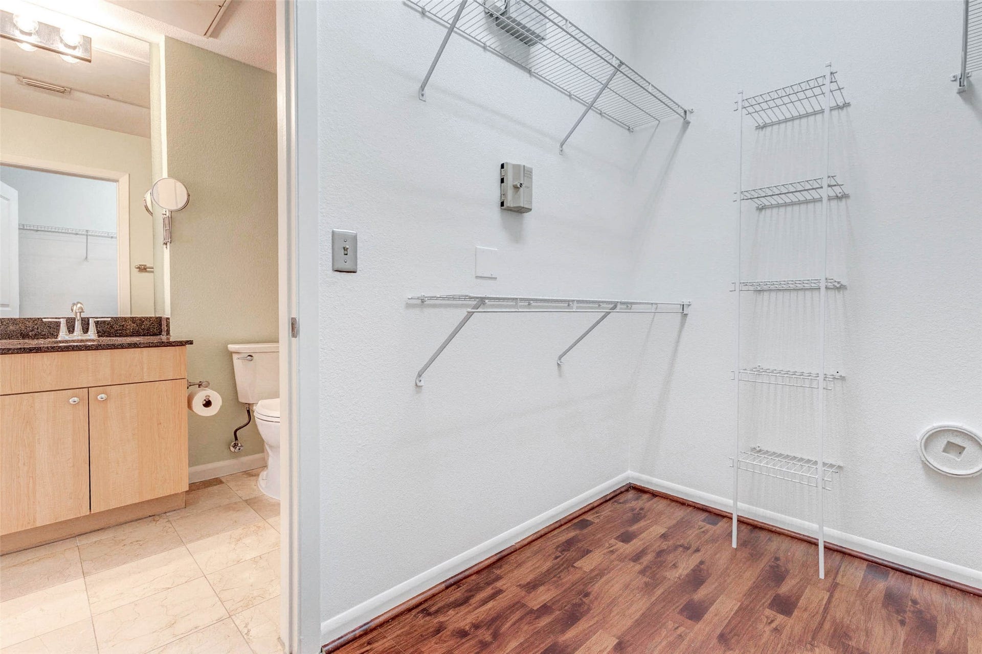 3505 Sage Road, #1104, Houston, TX 77056 The generous walk-in closet provides abundant storage space with multiple shelving levels designed to keep clothing, shoes, and accessories neatly organized. The open layout makes it easy to customize the space to fit your storage needs while maintaining a clean and efficient design. Located just off the primary bedroom and bathroom, this closet completes the comfortable suite layout and offers practical everyday convenience.