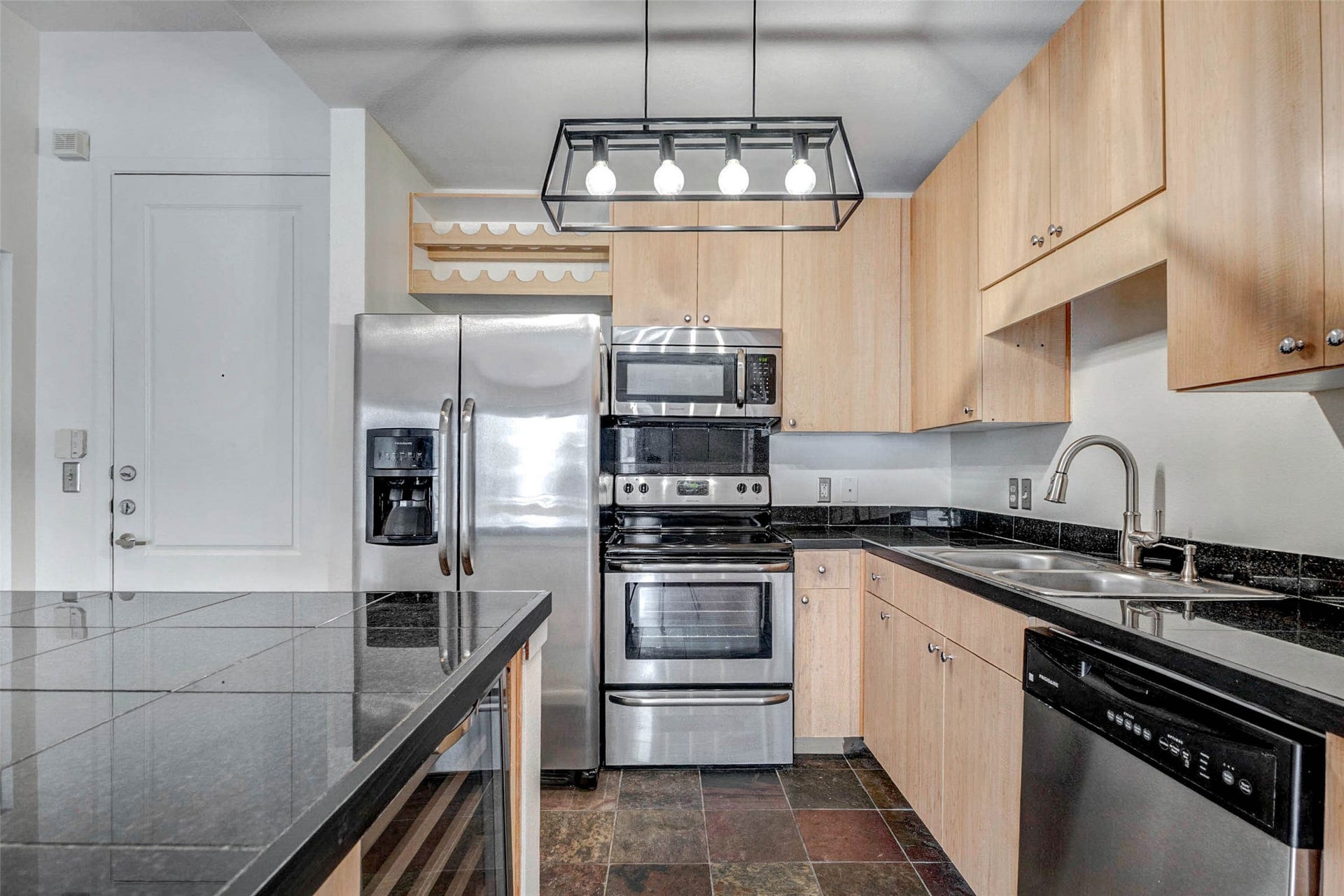 3505 Sage Road, #1104, Houston, TX 77056 This full view of the kitchen showcases its smart design and modern finishes. Stainless steel appliances, sleek countertops, and warm wood cabinetry combine to create a kitchen that feels both contemporary and inviting. The open layout allows the cook to stay connected with guests in the living room while preparing meals. With plenty of counter space, cabinet storage, and a central island, this kitchen is perfectly suited for both daily living and entertaining.