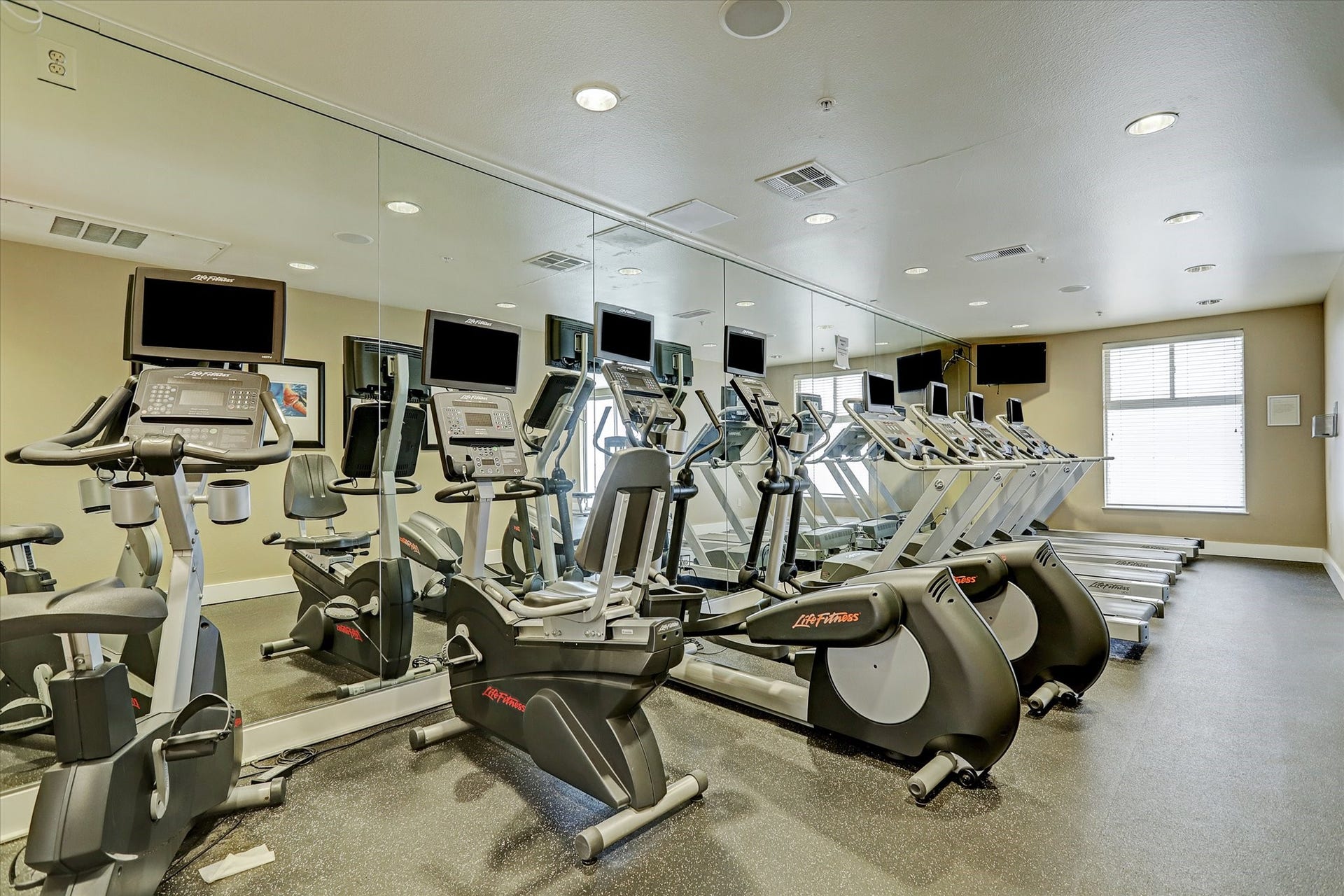 3505 Sage Road, #1104, Houston, TX 77056 Residents enjoy access to a fully equipped fitness center designed to support an active lifestyle without leaving the building. The facility features modern cardio equipment including treadmills, stationary bikes, and elliptical machines, all arranged in a spacious and well-lit environment. Wall-length mirrors enhance the open feel while allowing residents to comfortably complete workouts and stay energized just steps from home.