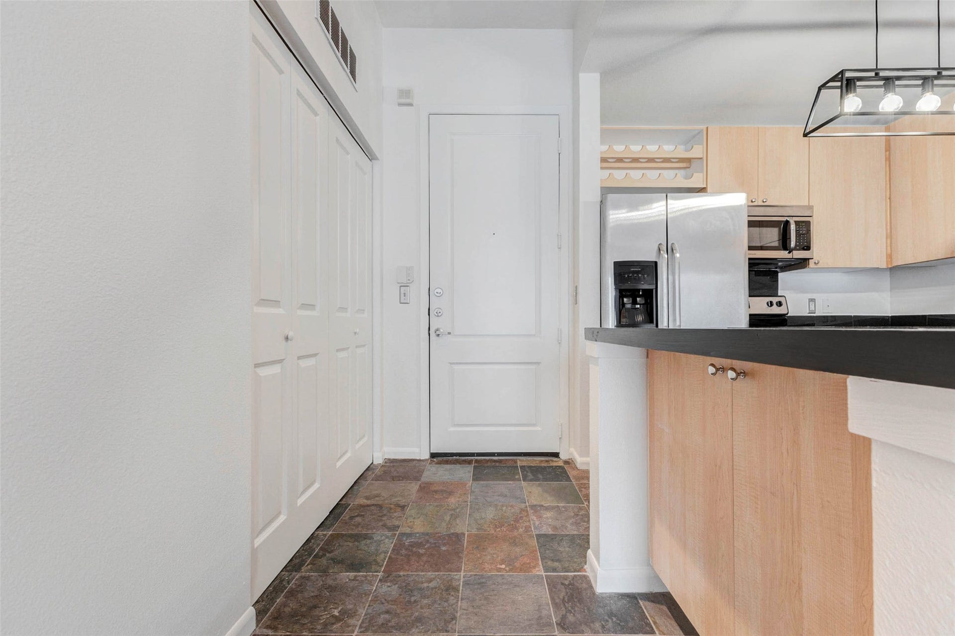 3505 Sage Road, #1104, Houston, TX 77056 Step inside and youre welcomed by a bright entryway that opens into a stylish and functional kitchen area. Durable tile flooring transitions beautifully from the front entry into the kitchen, while sleek cabinetry and stainless steel appliances create a contemporary feel. A spacious breakfast bar and counter area provide the perfect spot for casual dining or entertaining. The open layout makes the home feel larger while offering a natural flow from the entry into the main living space beyond.