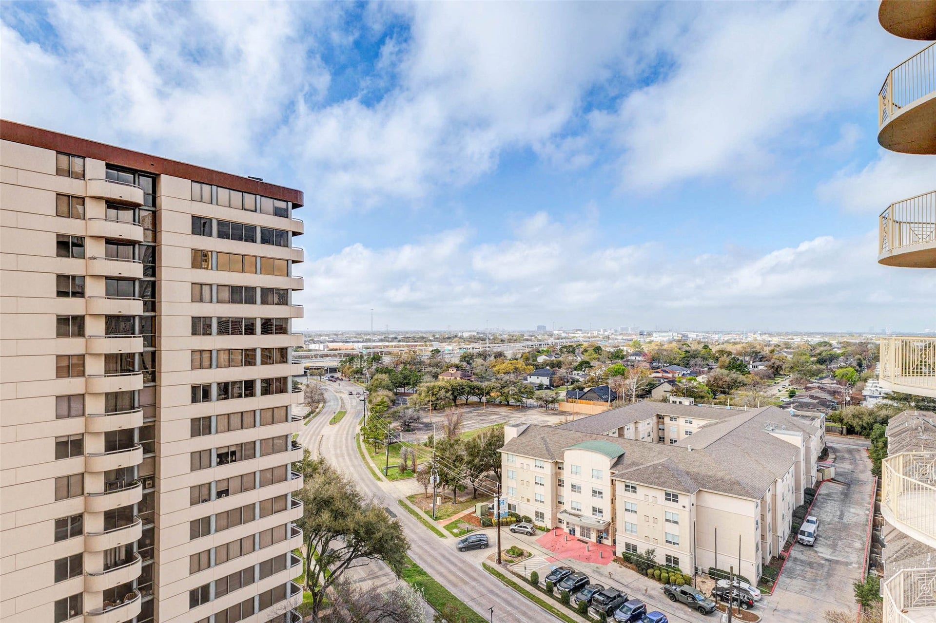 3505 Sage Road, #1104, Houston, TX 77056 This stunning balcony perspective captures the expansive views surrounding The Mark, showcasing neighboring high-rise buildings, quiet residential streets, and the distant Houston skyline. From the 11th floor, residents enjoy a peaceful vantage point above the city with wide open skies and beautiful natural light. The balcony offers an ideal outdoor extension of the living space where you can relax, entertain guests, and enjoy the dynamic scenery of the Galleria area.