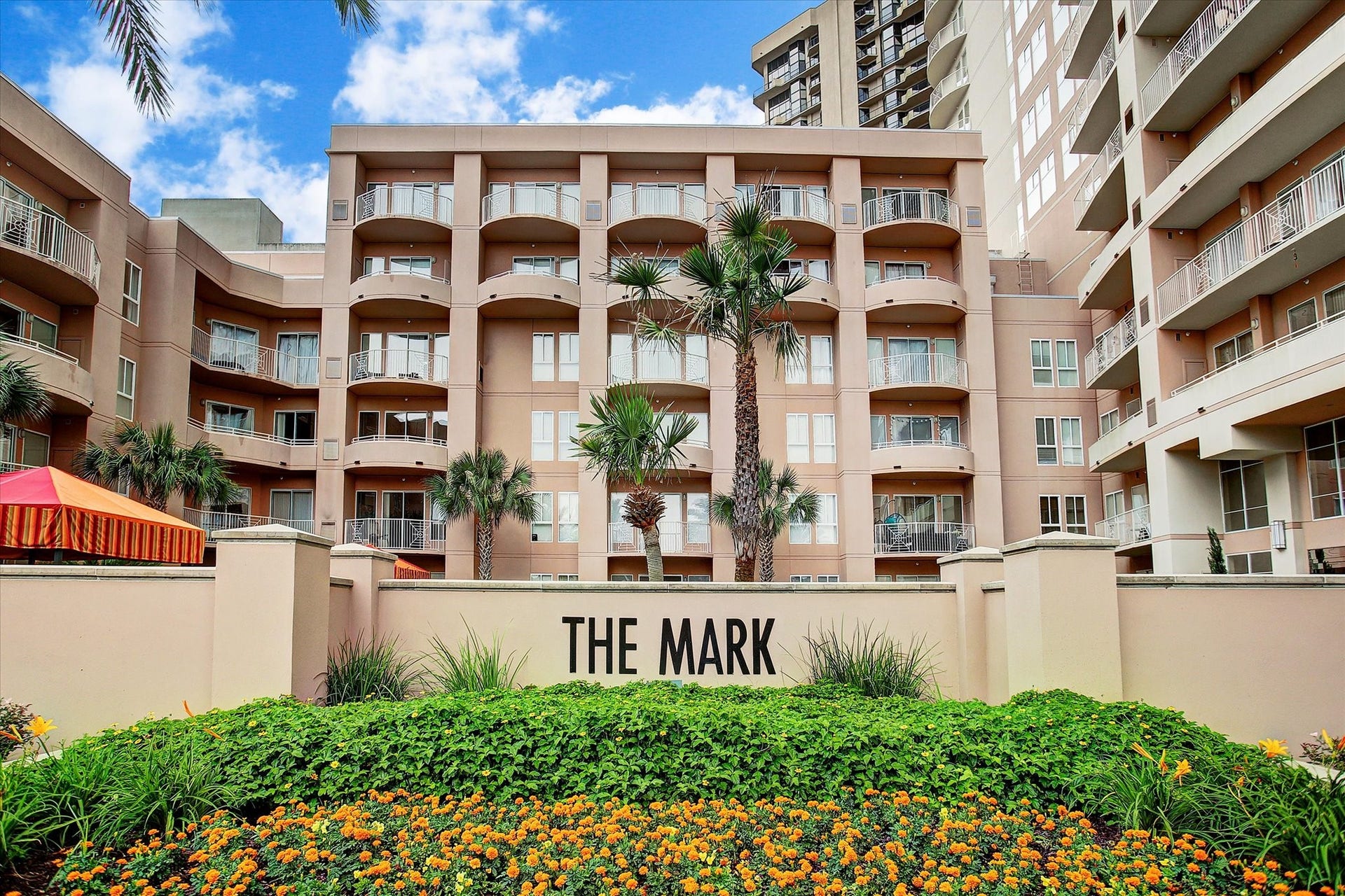 3505 Sage Road, #1104, Houston, TX 77056 The beautifully landscaped courtyard at The Mark welcomes residents and guests with lush greenery, colorful seasonal flowers, and elegant architectural details. The community signage sits prominently in front of the building, highlighting the upscale atmosphere of this sought-after Galleria high-rise. This well-maintained outdoor space reflects the pride of ownership and attention to detail found throughout the community.