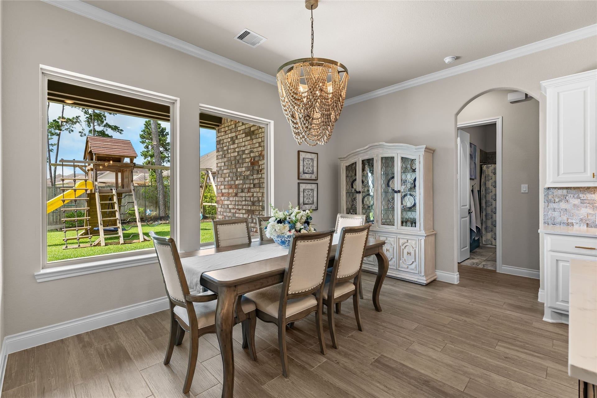 40803 Mostyn Drive, Magnolia, TX 77354 Dining area framed by large windows overlooking the backyard