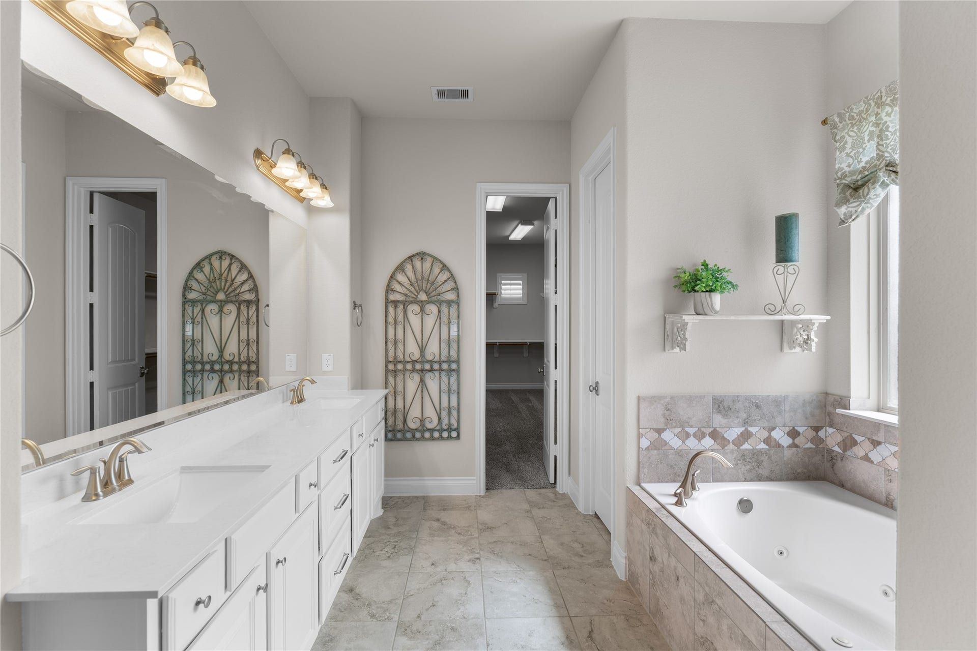 40803 Mostyn Drive, Magnolia, TX 77354 Spa-inspired primary bath with dual vanities, soaking tub, and oversized shower.