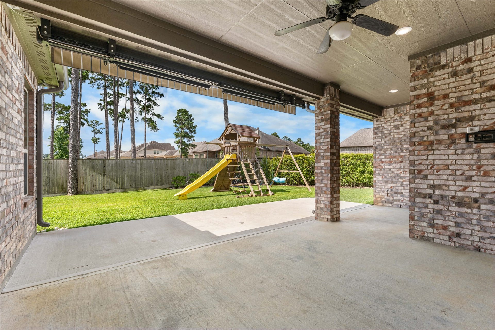 40803 Mostyn Drive, Magnolia, TX 77354 Covered back patio perfect for outdoor dining and entertaining year-round.
