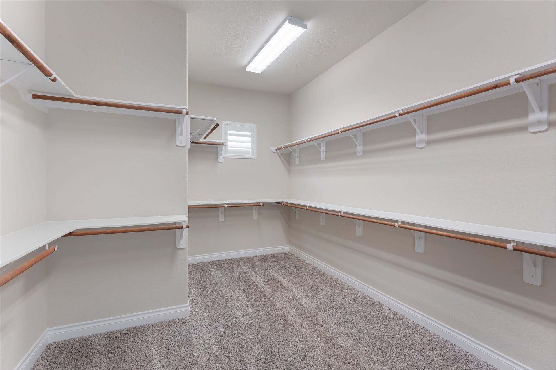 40803 Mostyn Drive, Magnolia, TX 77354 Expansive walk-in closet with custom built-ins and exceptional storage.