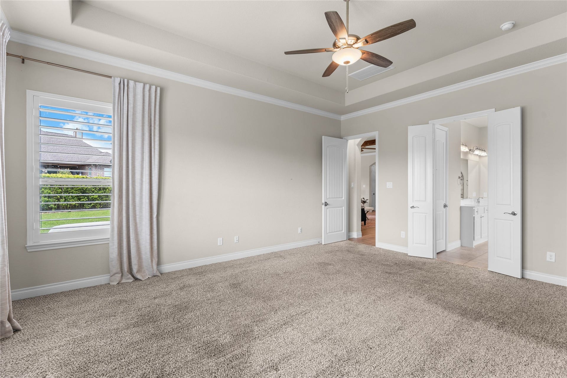 40803 Mostyn Drive, Magnolia, TX 77354 Spacious primary suite filled with natural light and calming neutral tones.