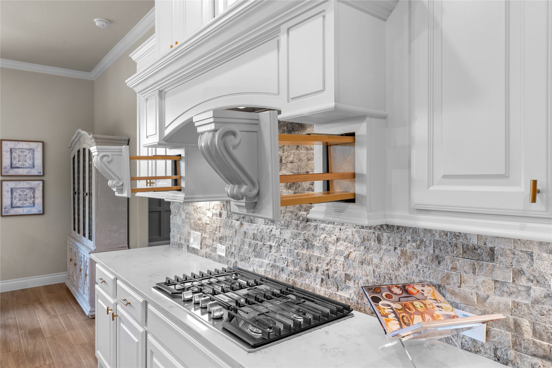 40803 Mostyn Drive, Magnolia, TX 77354 Designer finishes with custom cabinets and gas cooktop create a polished culinary space