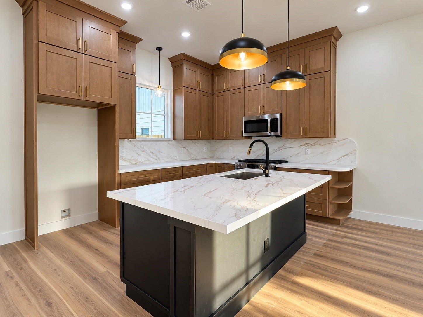 8018 Moon Beam Street, #A/B, Houston, TX 77088 Elegant kitchen featuring rich wood cabinetry, natural lighting complemented by modern lighting and stainless steel appliances.This photo has been virtually rendered based on the plans for this home.