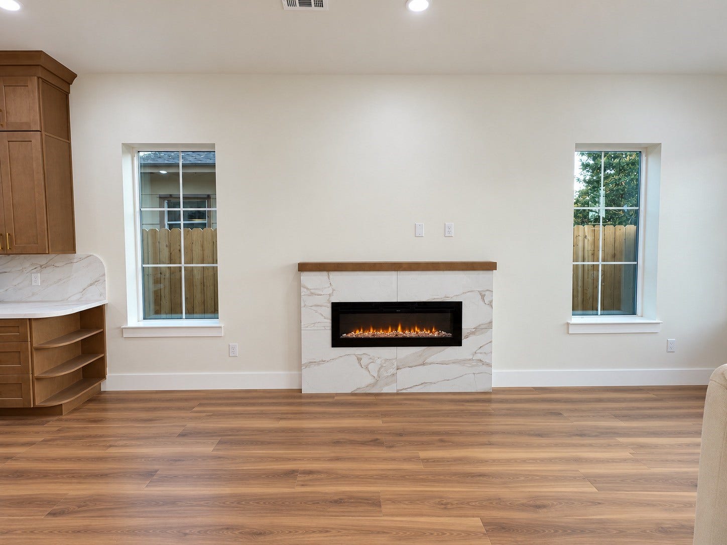 8018 Moon Beam Street, #A/B, Houston, TX 77088 Chic living space featuring a modern electric fireplace and ample natural light from large windows.This photo has been virtually rendered based on the plans for this home.