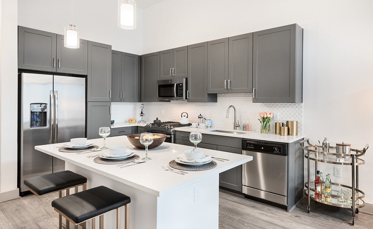 180 Malone Street, #2317, Houston, TX 77007 Model has a has abundant cabinet space ,side by side refrigerator, a dining island which frees up space in the living area with pendant lighting