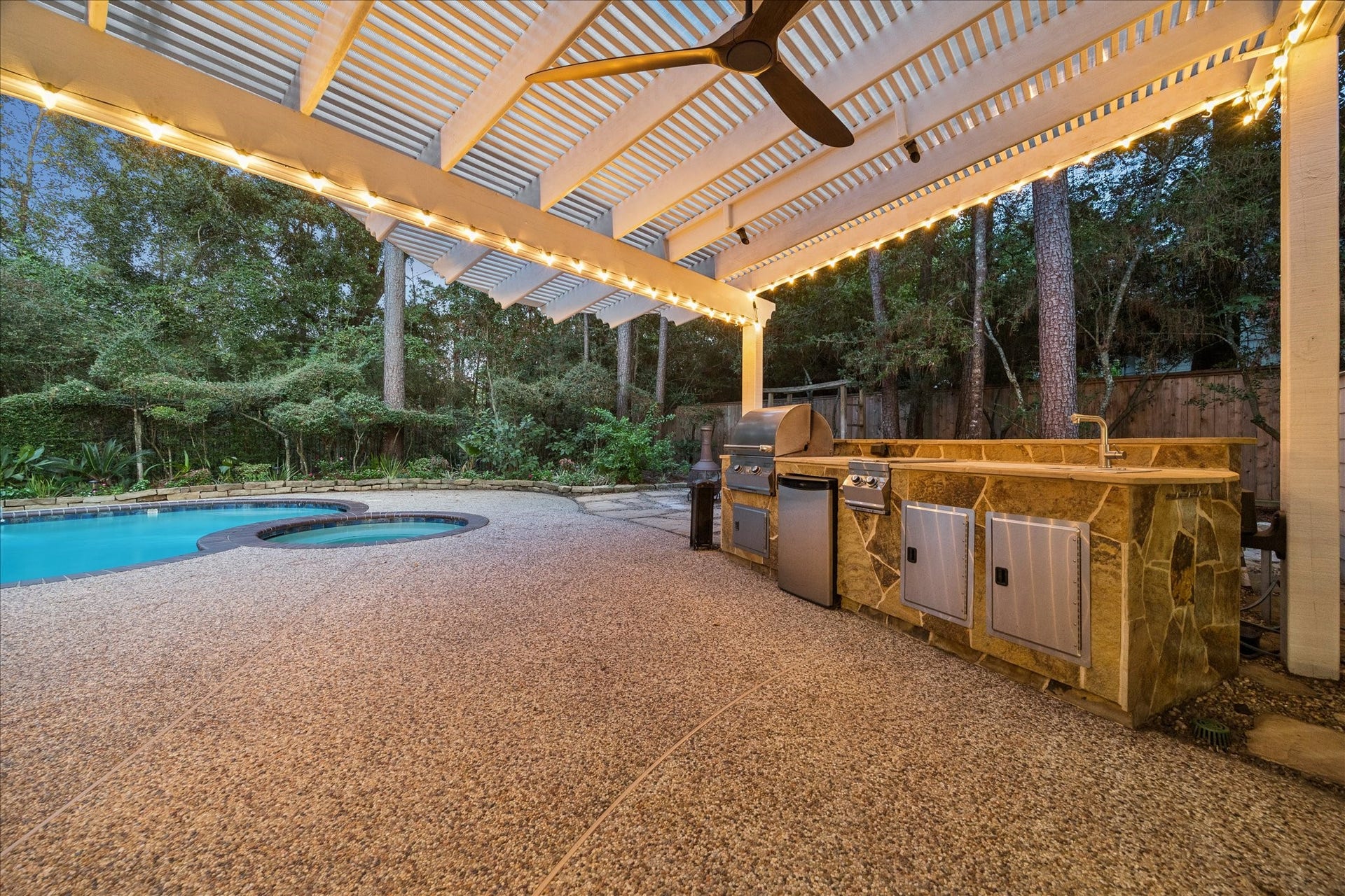 Covered outdoor kitchen and pergola creating an ideal space for entertaining.