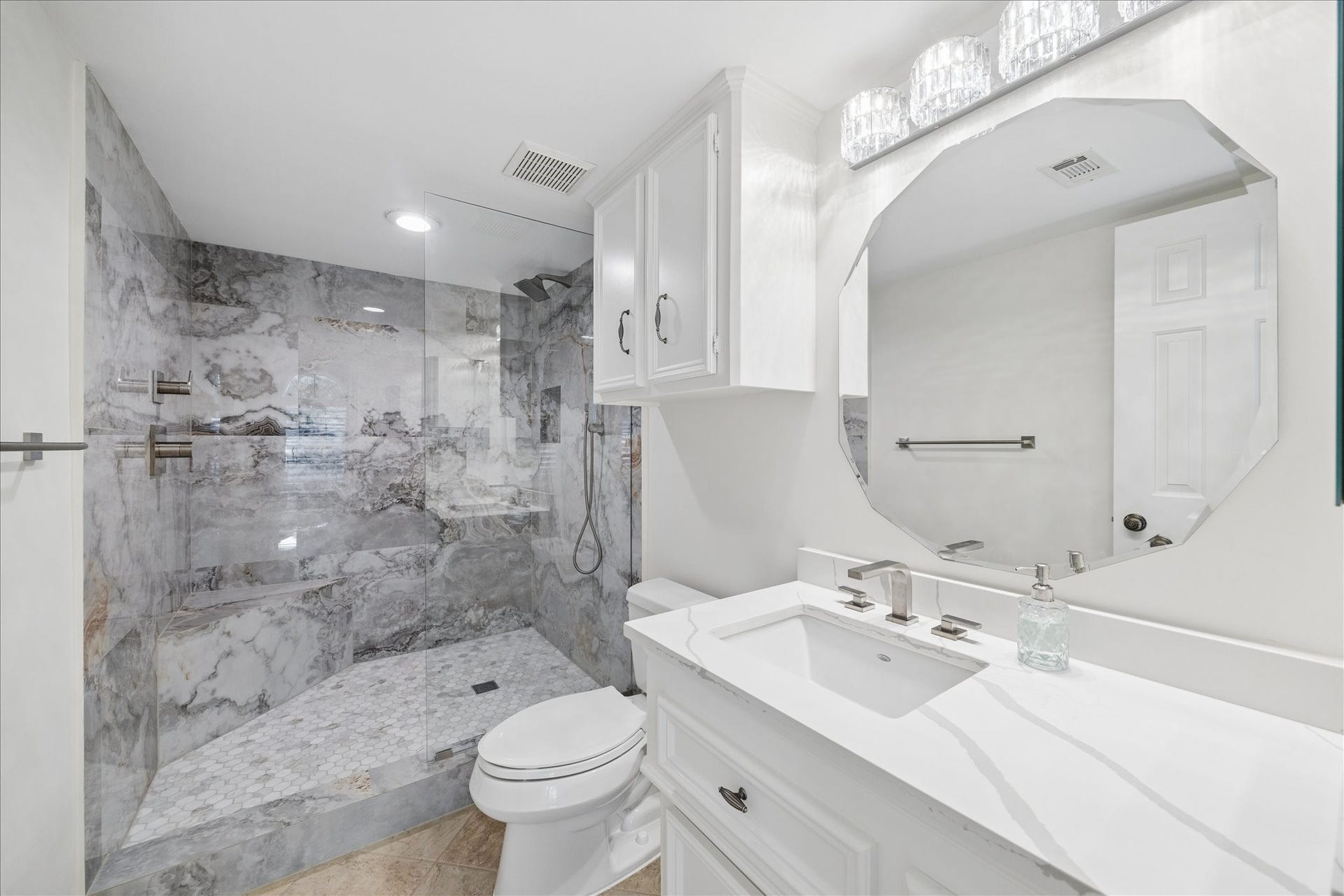 Updated private guest secondary bath featuring clean lines and sophisticated finishes.
