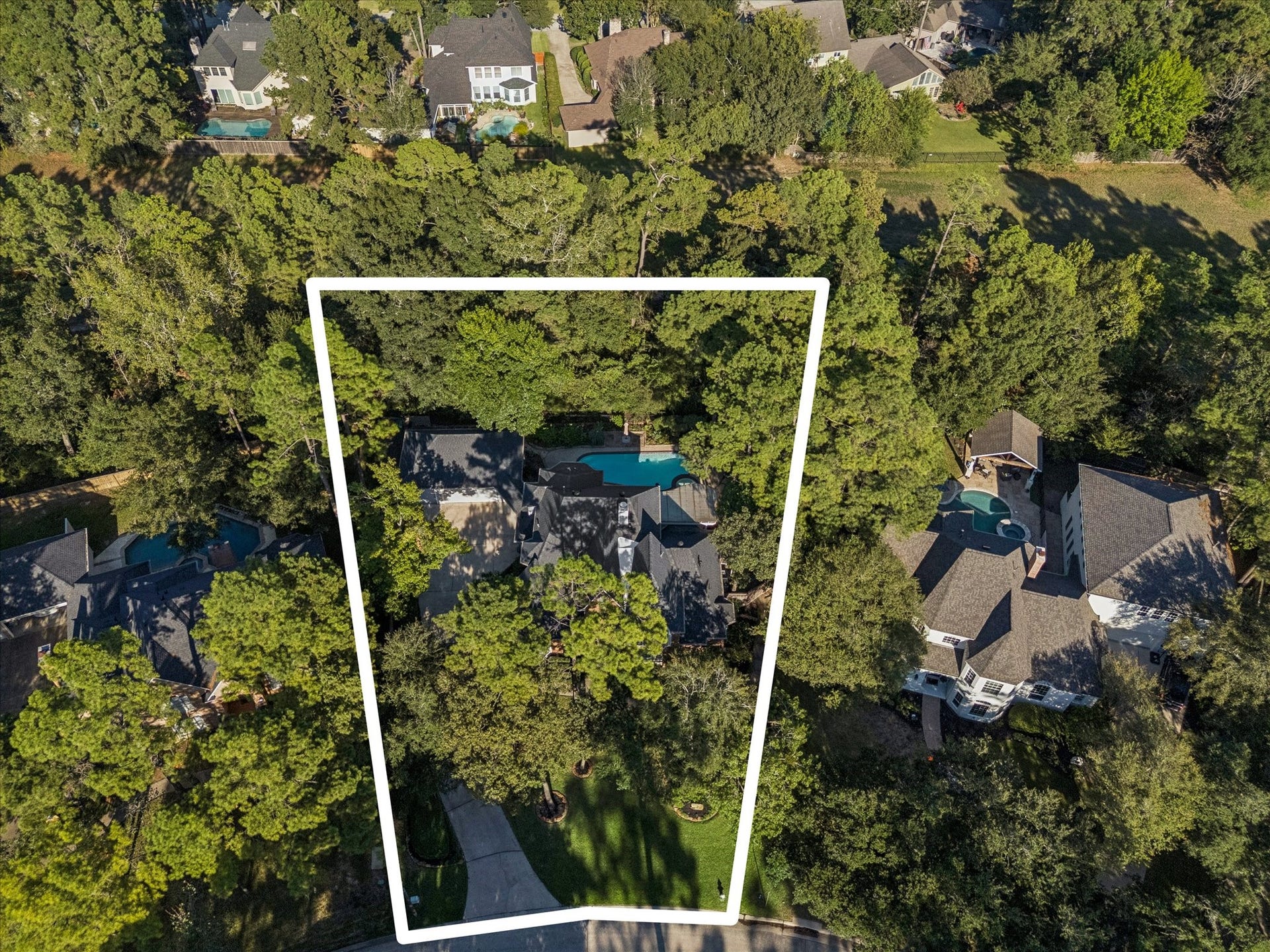 Aerial perspective showcasing the home's wooded surroundings and natural setting.