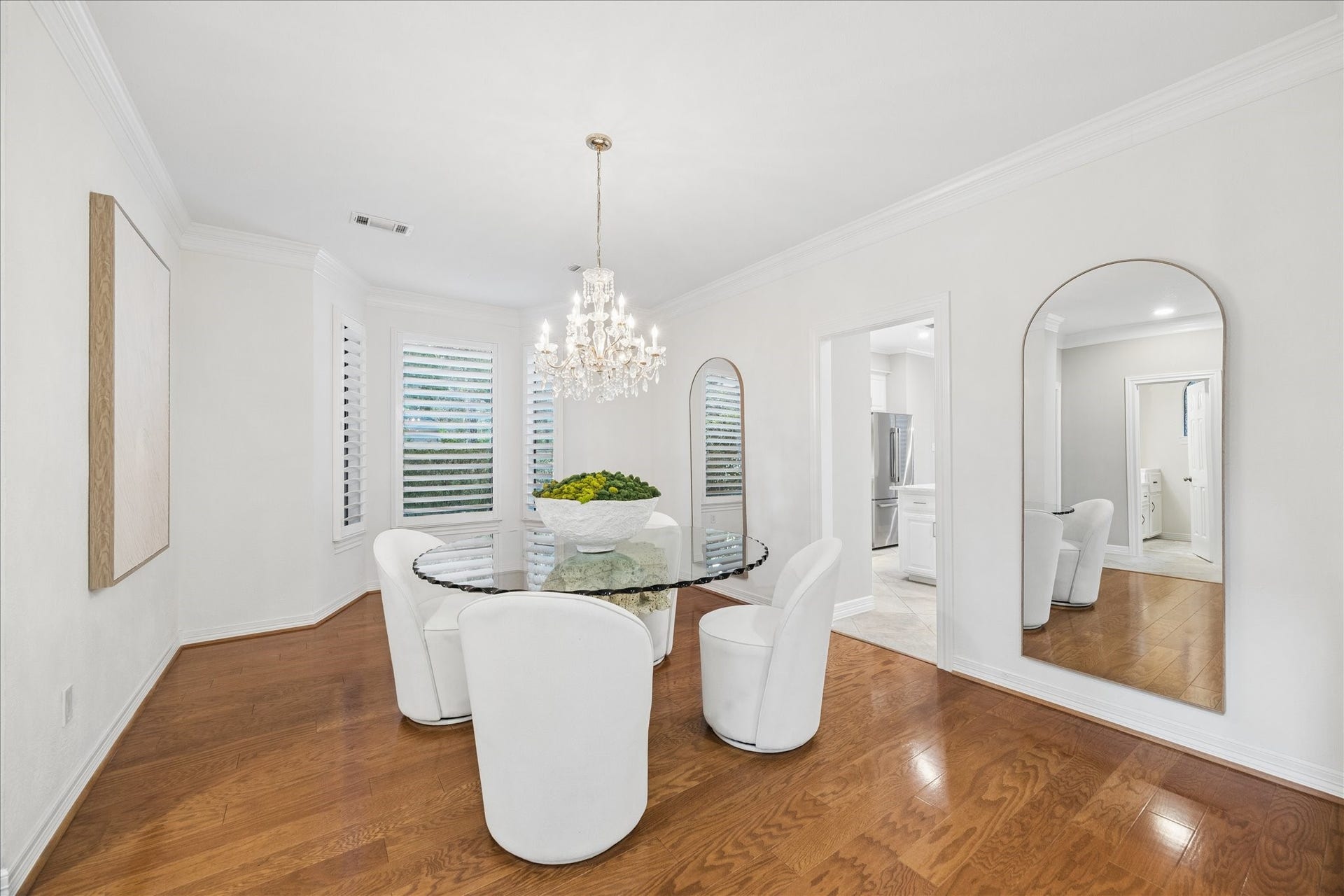 Elegant formal dining room enhanced by abundant natural light and refined architectural details.
