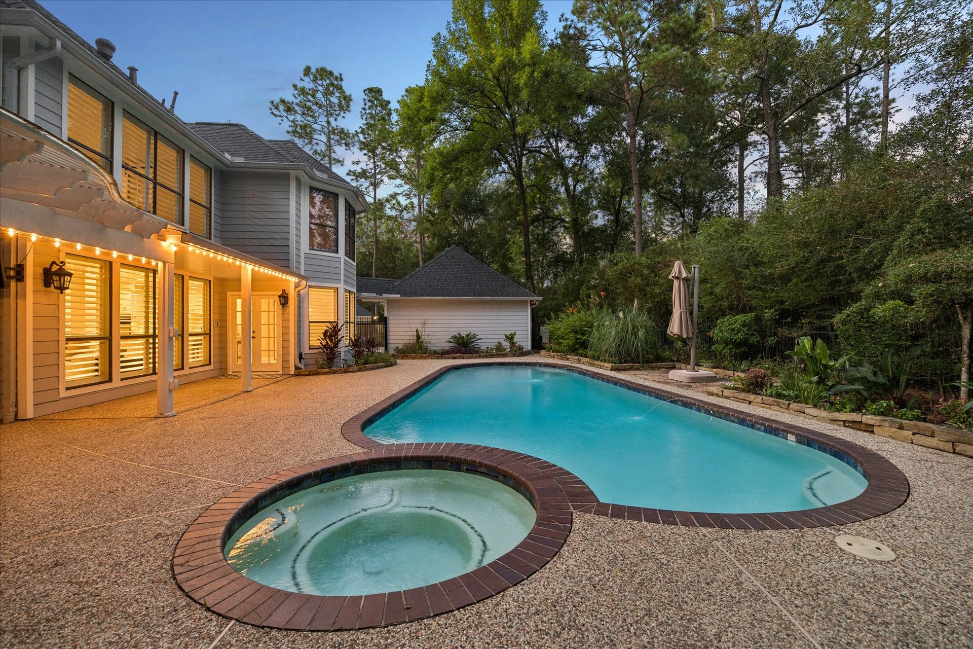 The spa retreat pool area sorrounded by nature and privacy, mature trees and manicure landscape.