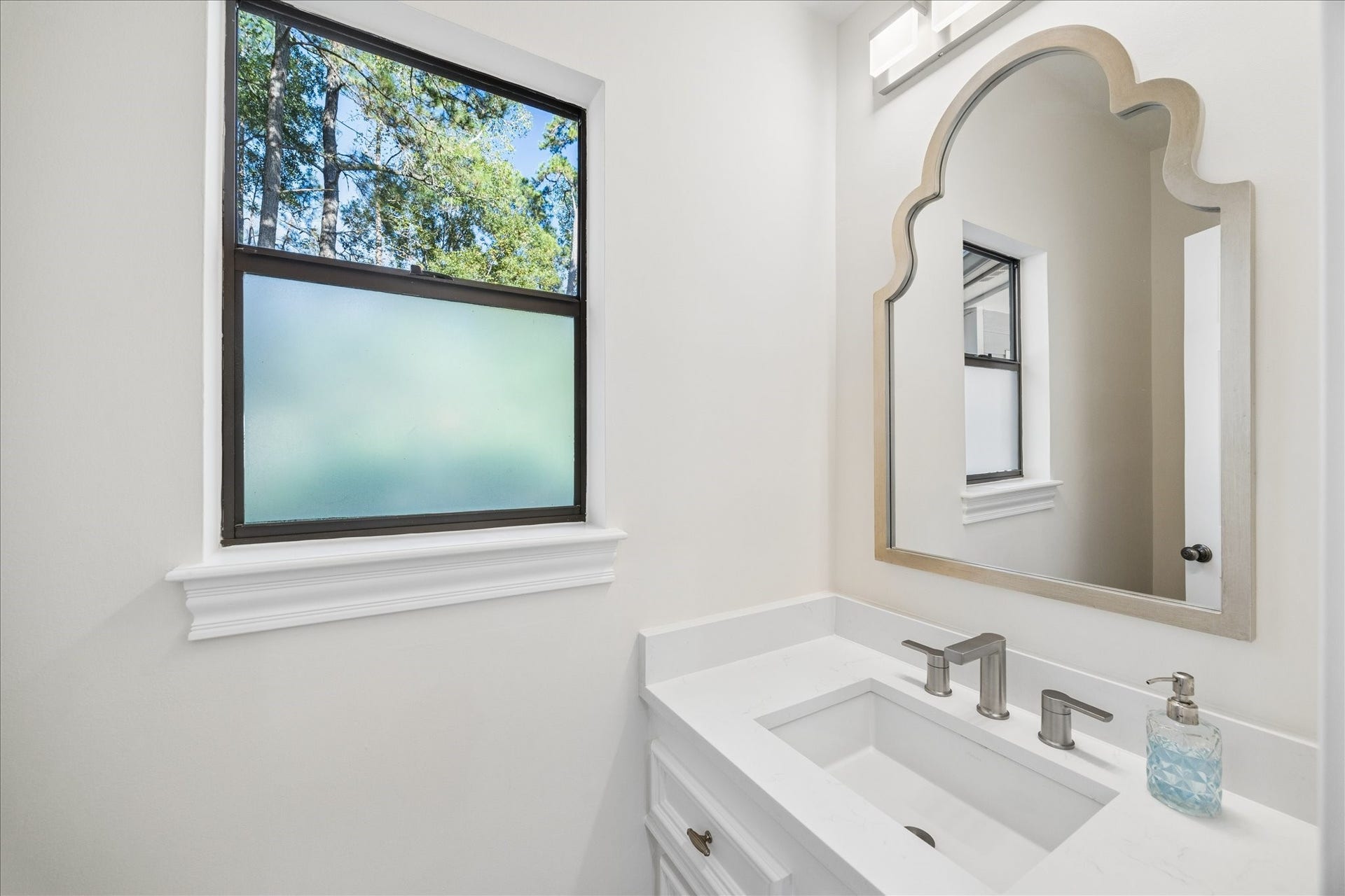 Beautifully renovated powder bath featuring updated finishes and fixtures.