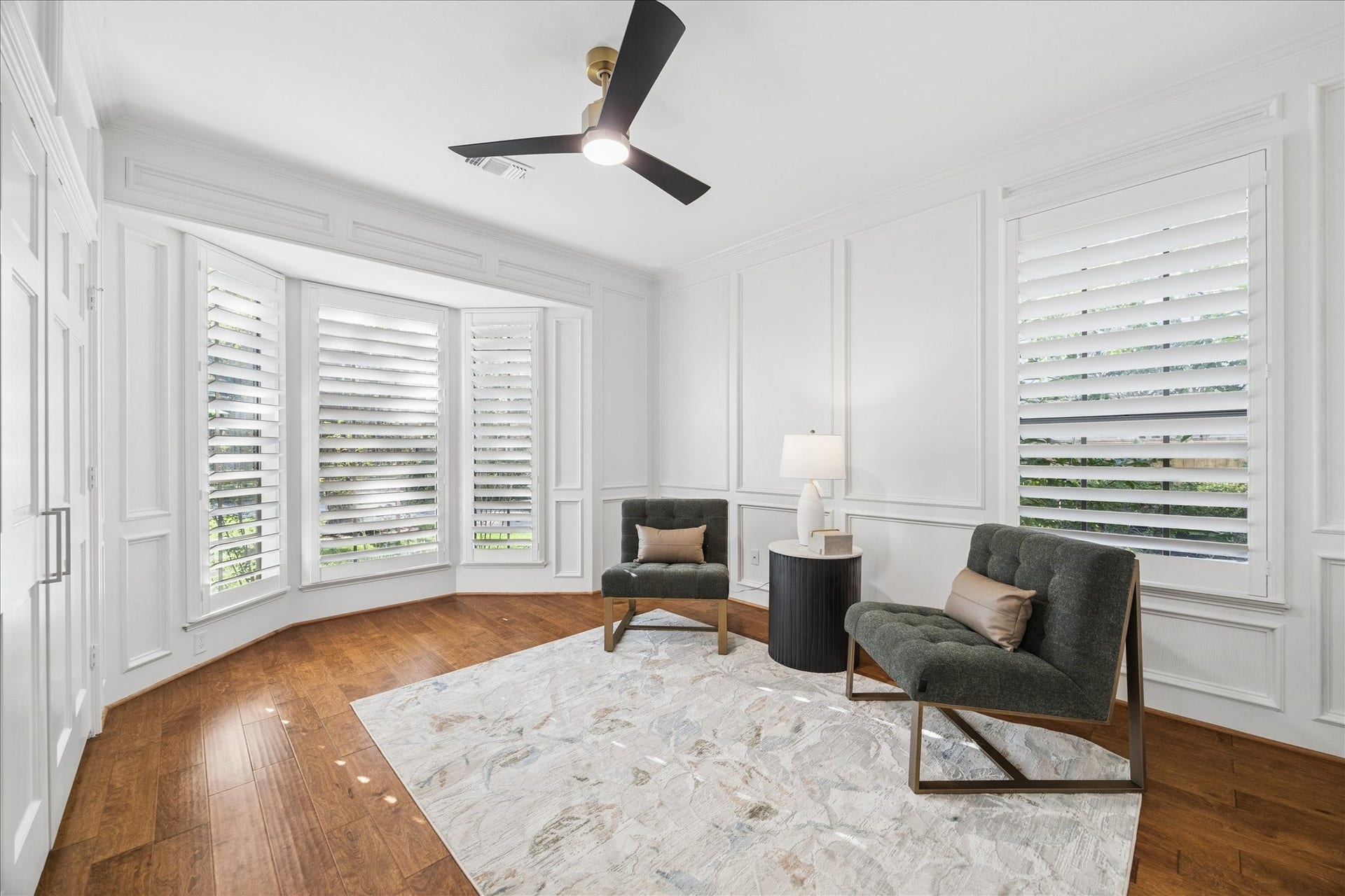 Executive office featuring custom millwork, plantation shutters, and elevated finishes.