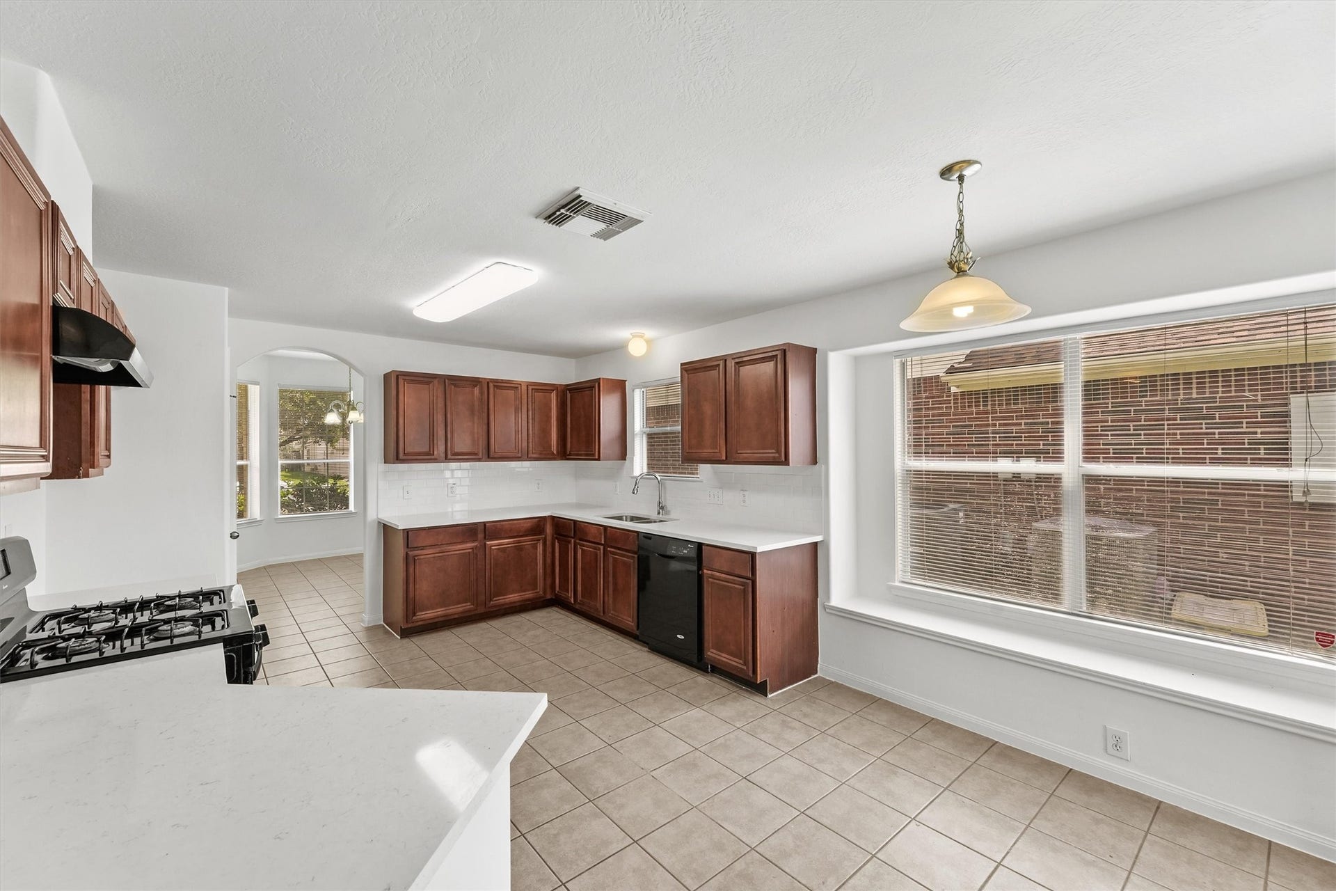 There is plenty of room to work in this kitchen and from here you can see the dining room and it's bay window.