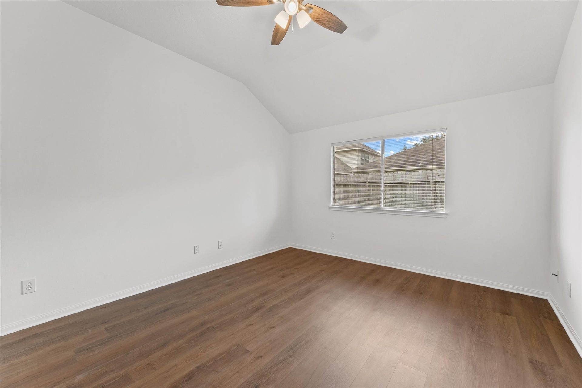 The primary bedroom has new floors and a raised ceiling.