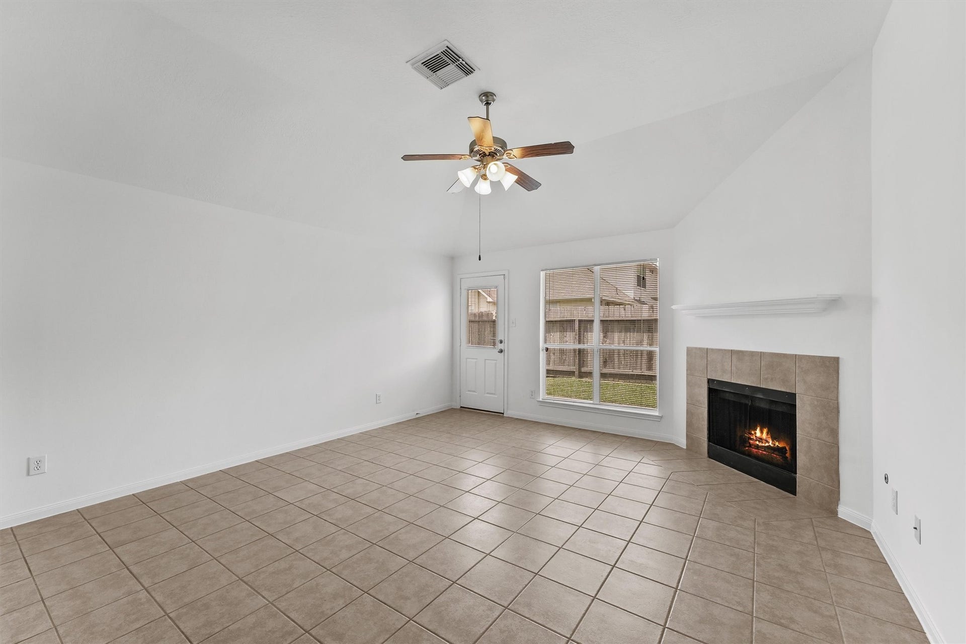 The living room can accommodate many furniture set ups.