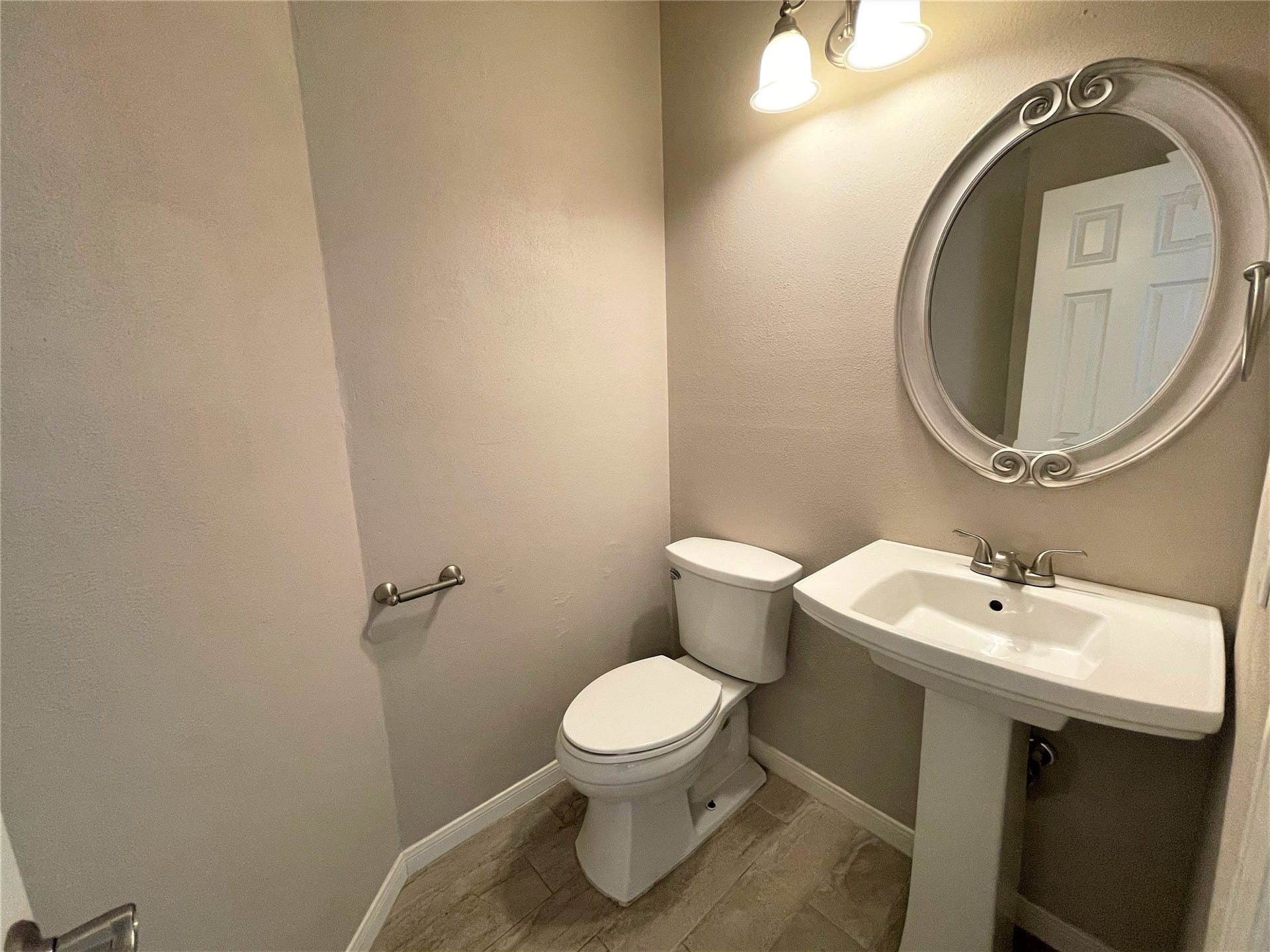 8406 Lake Crystal Drive, Houston, TX 77095 This half bathroom, while compact, serves as a stylish retreat for guests, combining convenience with an aesthetic charm that leaves a lasting impression.