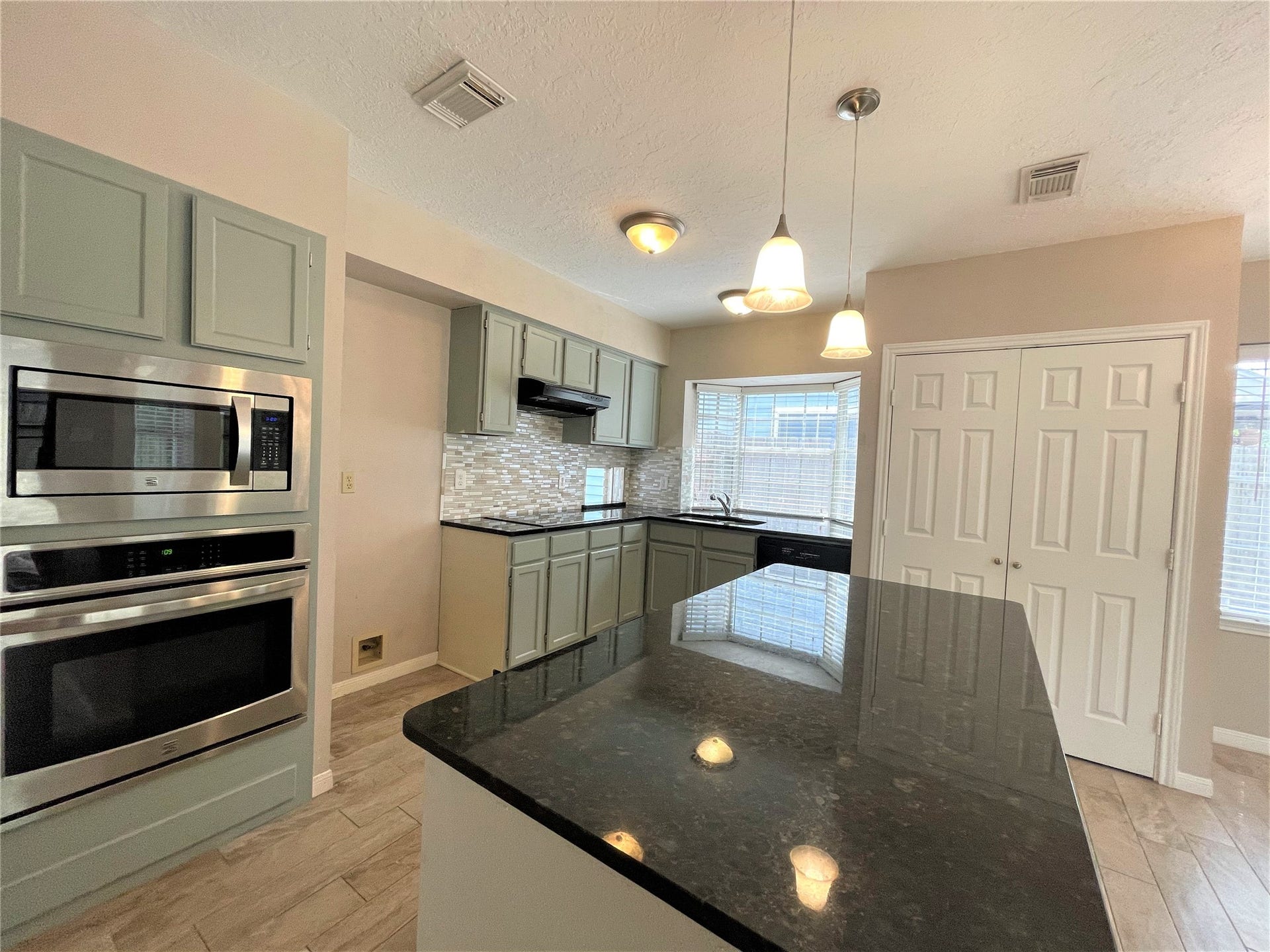 8406 Lake Crystal Drive, Houston, TX 77095 The centerpiece of the kitchen is a spacious island topped with elegant granite countertops, offering ample space for meal prep or casual dining. The sleek stainless steel appliances add a modern touch, making cooking a pleasure.