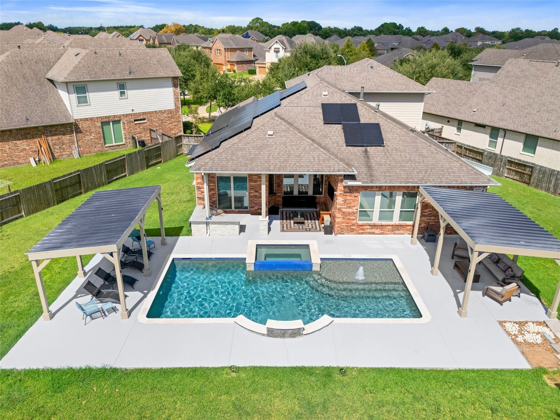 POOL & BACKYARD  Resort-style pool and spa surrounded by an expansive patio with multiple covered areas designed for lounging, dining, and entertaining.
