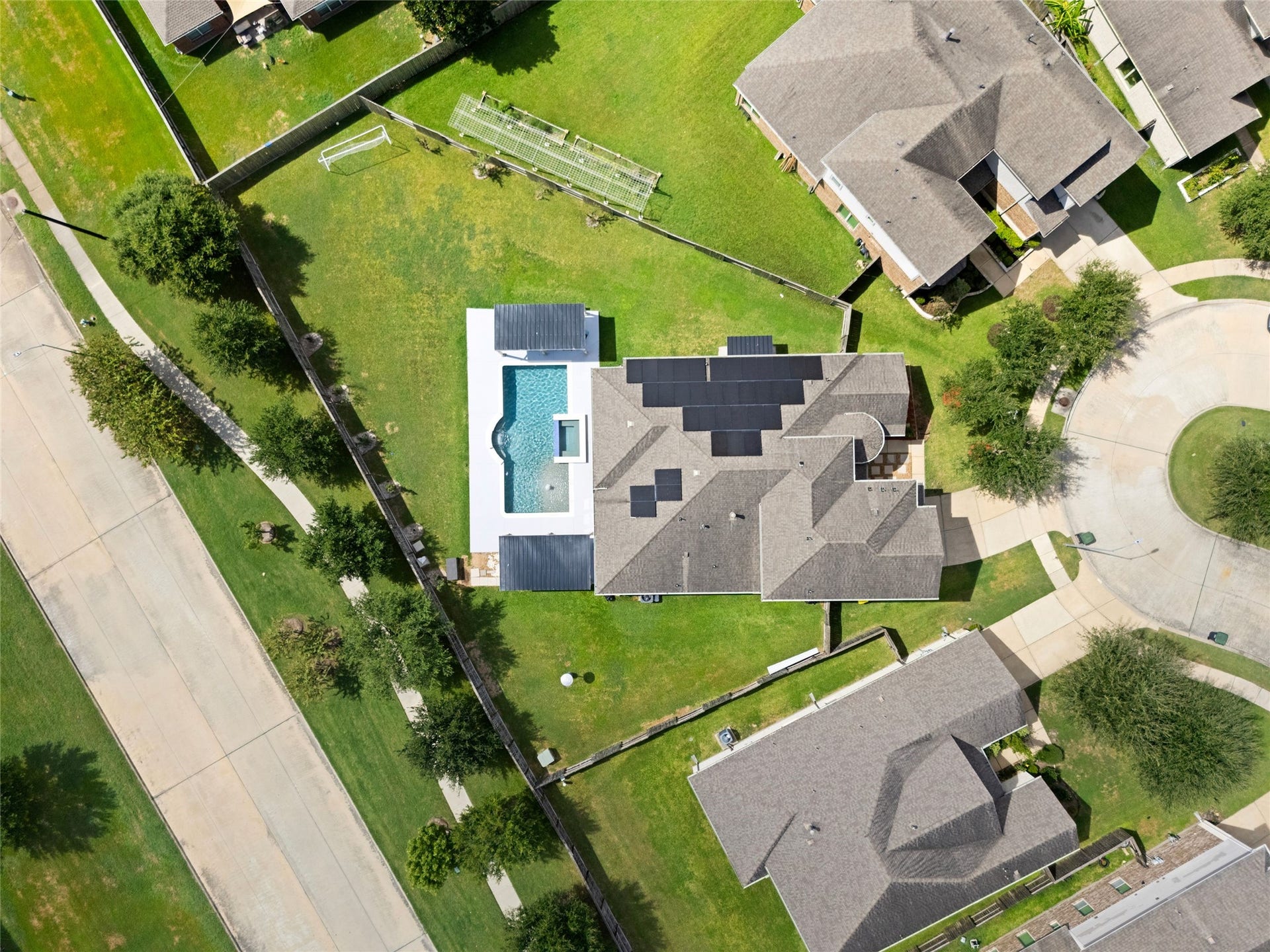 AERIAL VIEW II  Birds-eye view highlighting the homes oversized lot, solar panels, and cul-de-sac location.