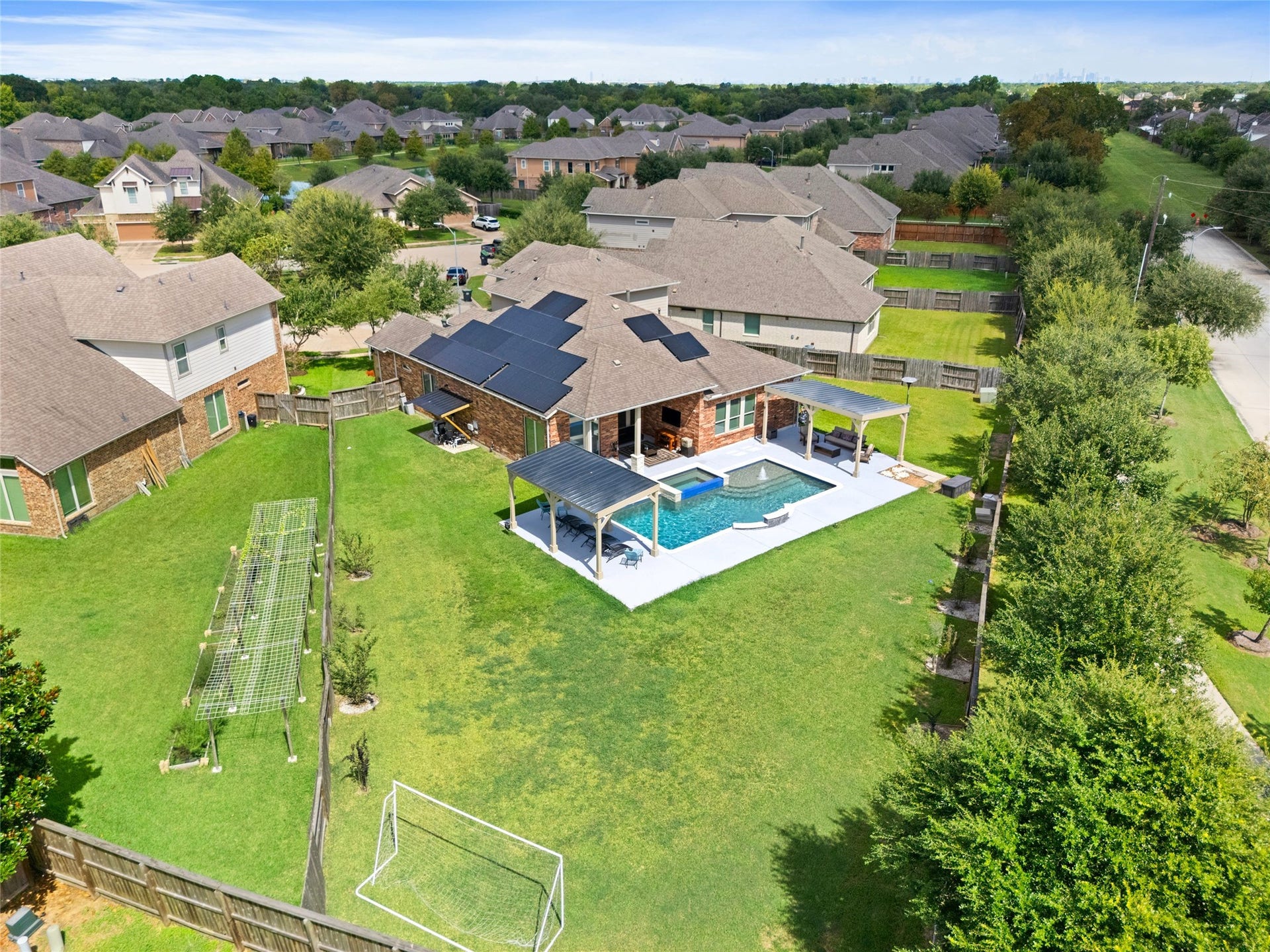 AERIAL VIEW  Expansive oversized cul-de-sac lot showcasing the resort-style backyard, pool, multiple covered outdoor living areas, and generous green space.
