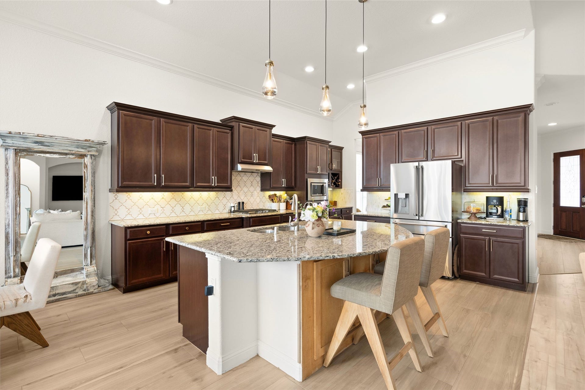 KITCHEN  Spacious kitchen featuring abundant cabinetry, granite countertops, statement backsplash and large island.