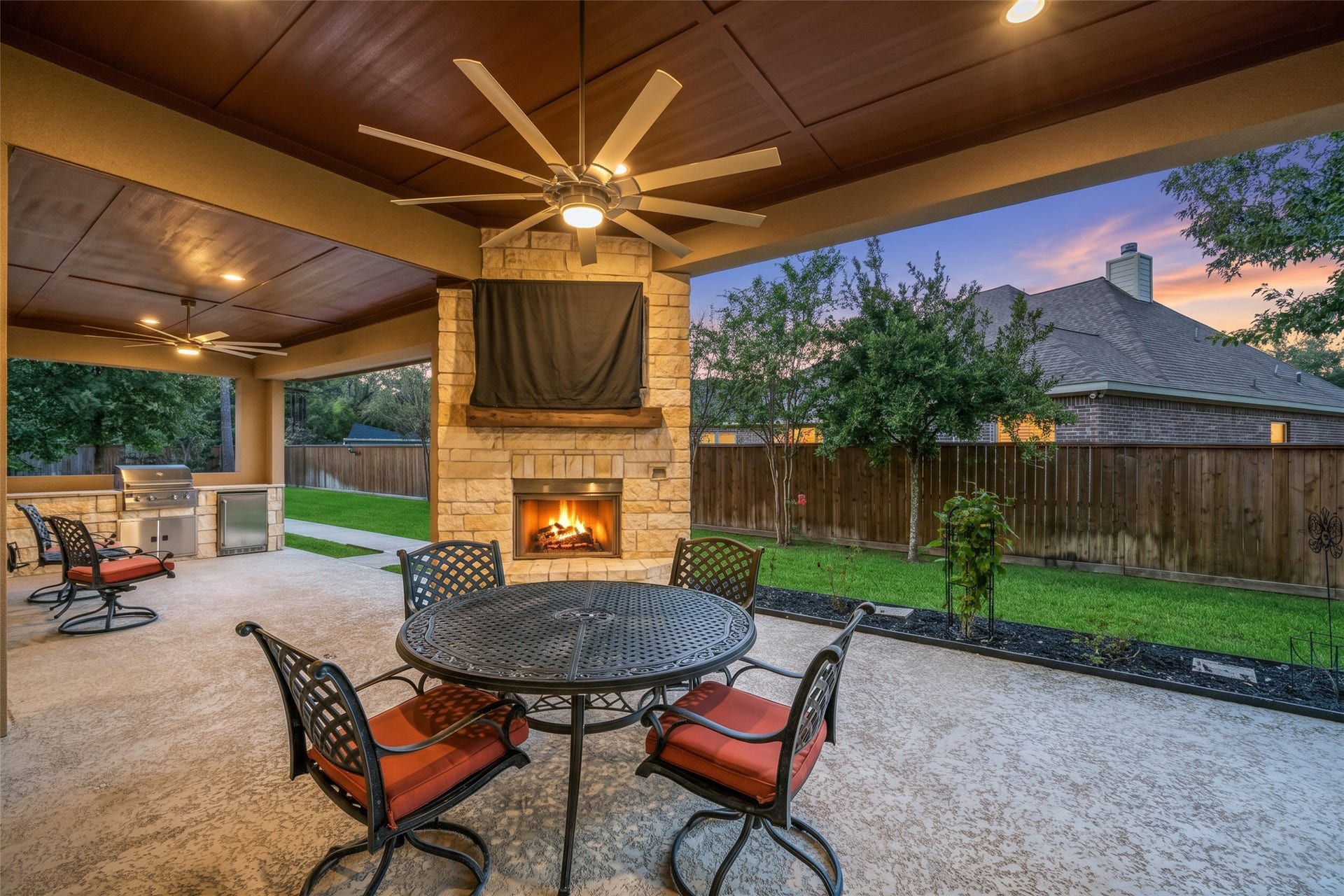 12606 Whitney Court, Magnolia, TX 77354 Relax and unwind on the oversized covered patio complete with outdoor fireplace and kitchen.
