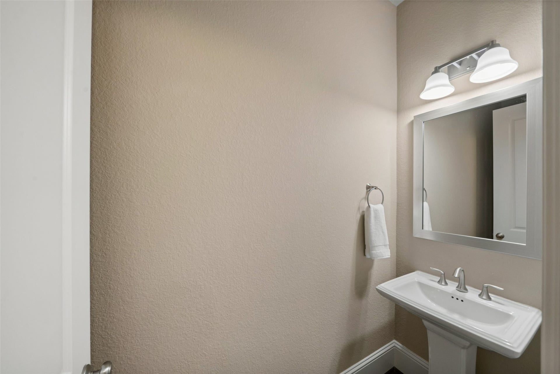 12606 Whitney Court, Magnolia, TX 77354 One of two half bathrooms, this one is on the first floor conveniently located for guests.