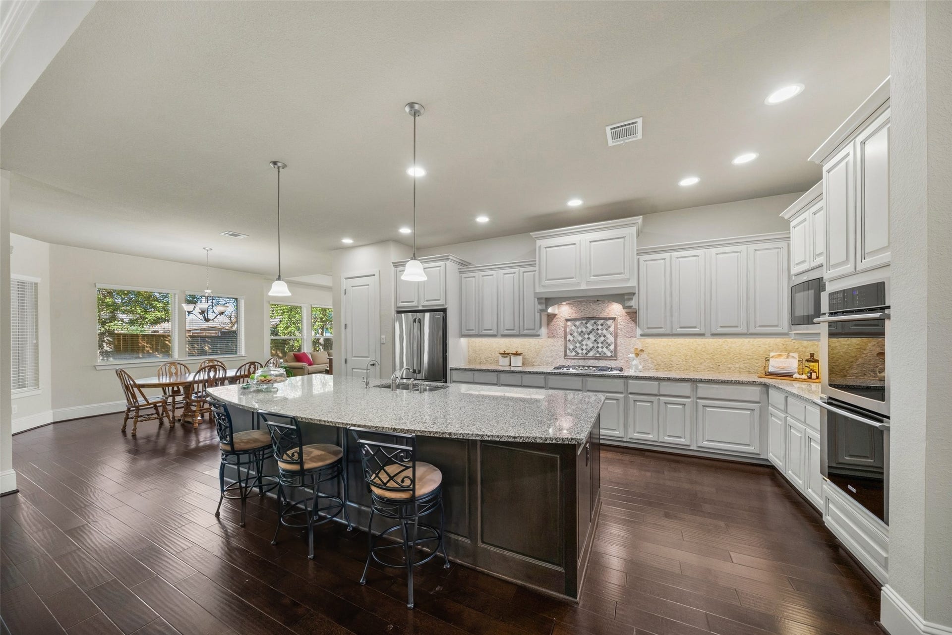 12606 Whitney Court, Magnolia, TX 77354 The kitchen serves as the heart of the home with high ceilings, double ovens, large walk in pantry and an abundance of cabinets. Easy sight lines into the family room, breakfast room and sun room.