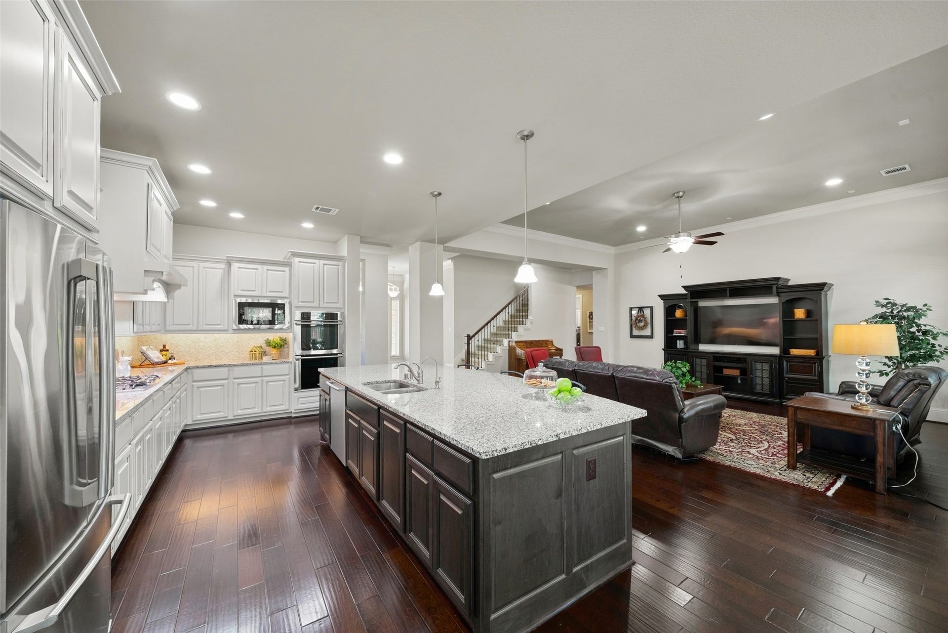 12606 Whitney Court, Magnolia, TX 77354 The spacious kitchen features an oversized island with seating for 6, double ovens, white cabinetry and a walk-in pantry.